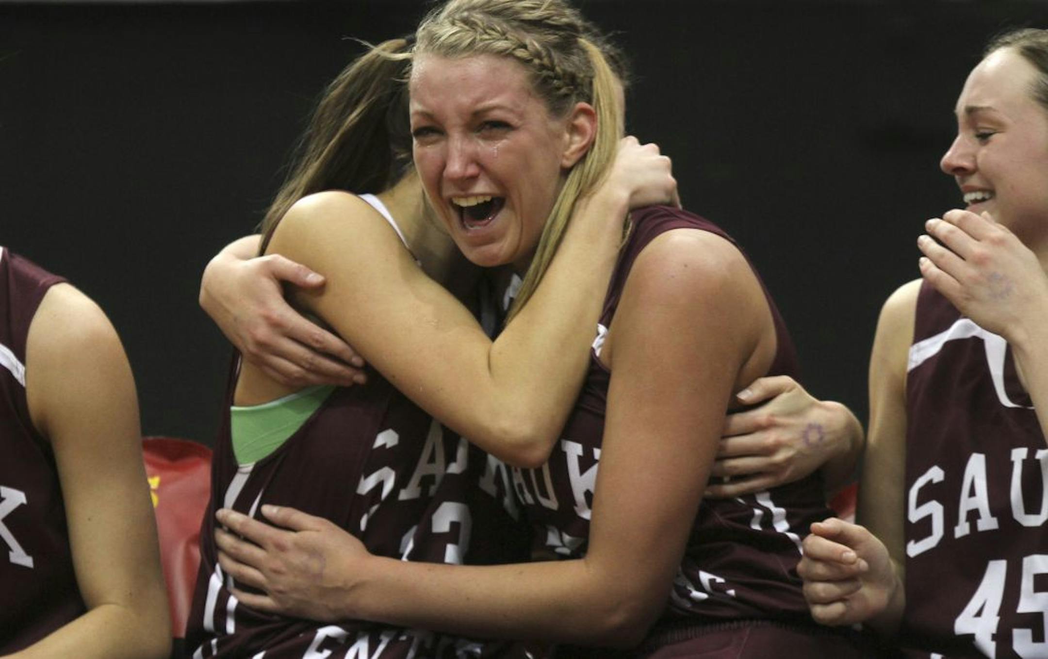 Sauk Centre's Kali Peschel, right, cried with happiness as she hugged her teammate Macy Weller with less than a minute left in the Class 2A semifinals at Target Center in Minneapolis Min., Friday, March 16, 2012. Sauk Centre won 56-39.