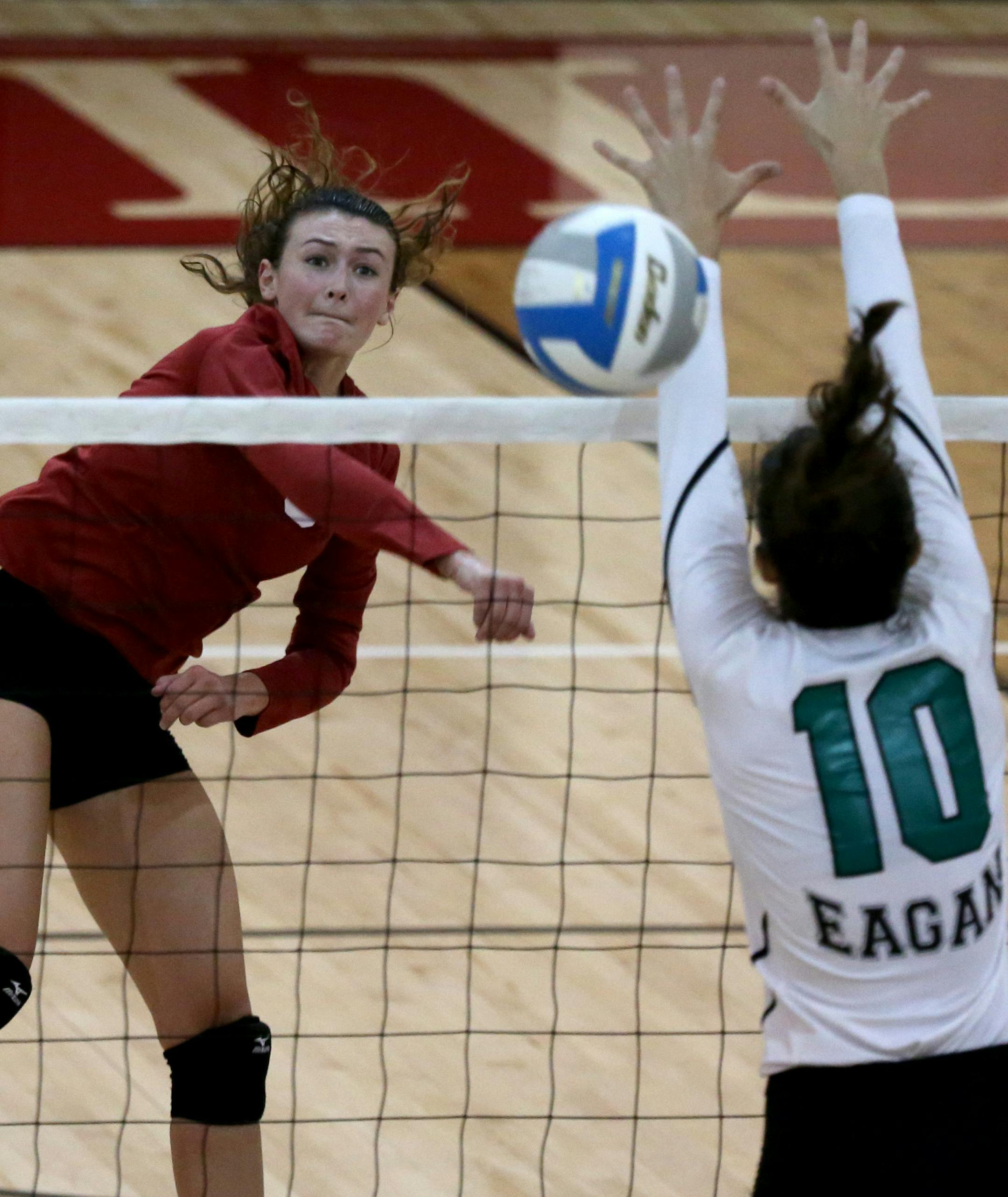 Lakeville South Halle Johnston spiked the ball passed Eagan's Alyssa Doucette. ] (KYNDELL HARKNESS/STAR TRIBUNE) kyndell.harkness@startribune.com Eagan vs Lakeville South in Lakeville Min., Thursday September 17, 2015.