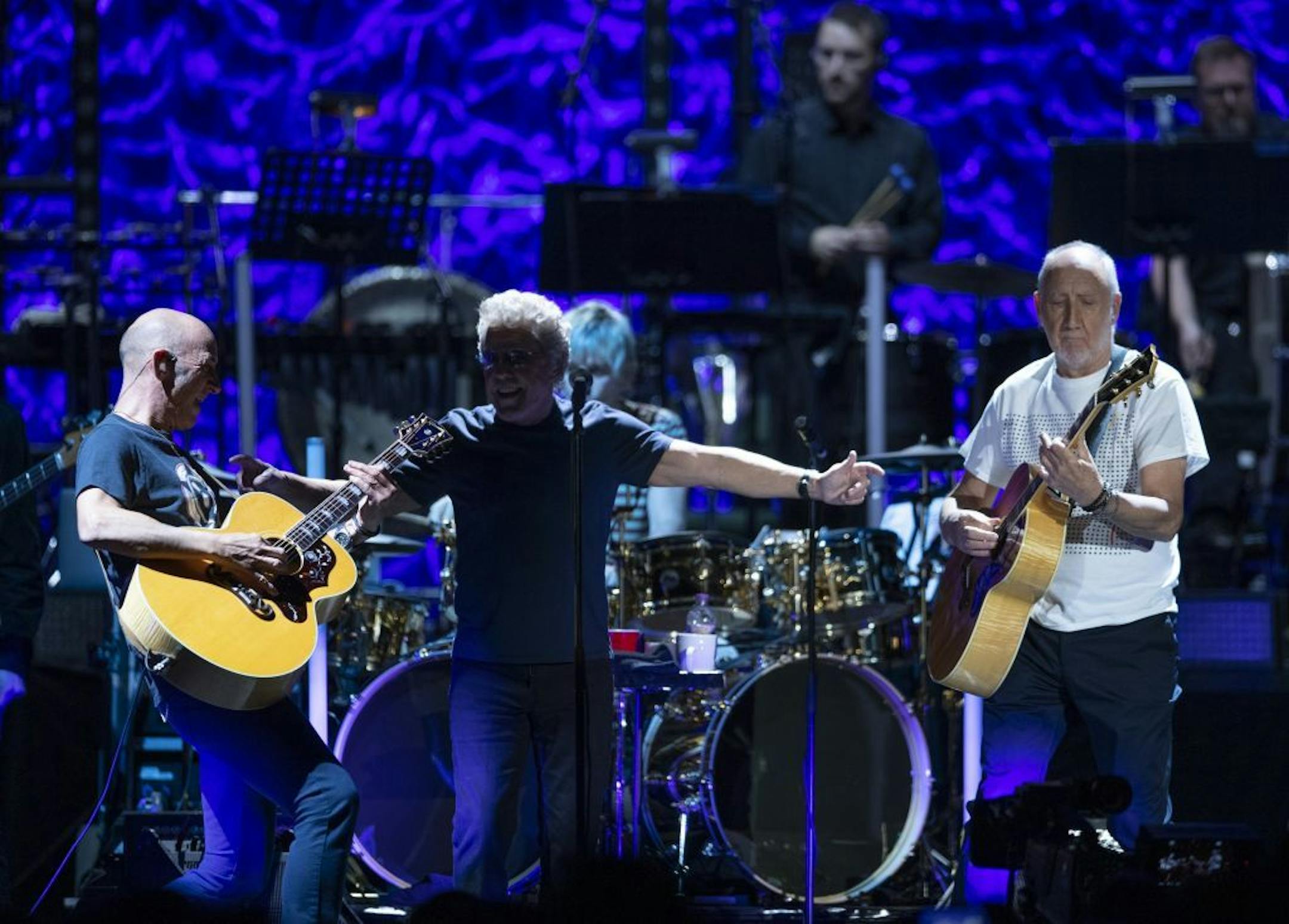 Lead singer Roger Daltrey was flanked by guitarist Pete Townshend, right, and Townshend's son, Simon Townshend early in The Who's show at Xcel Friday night.