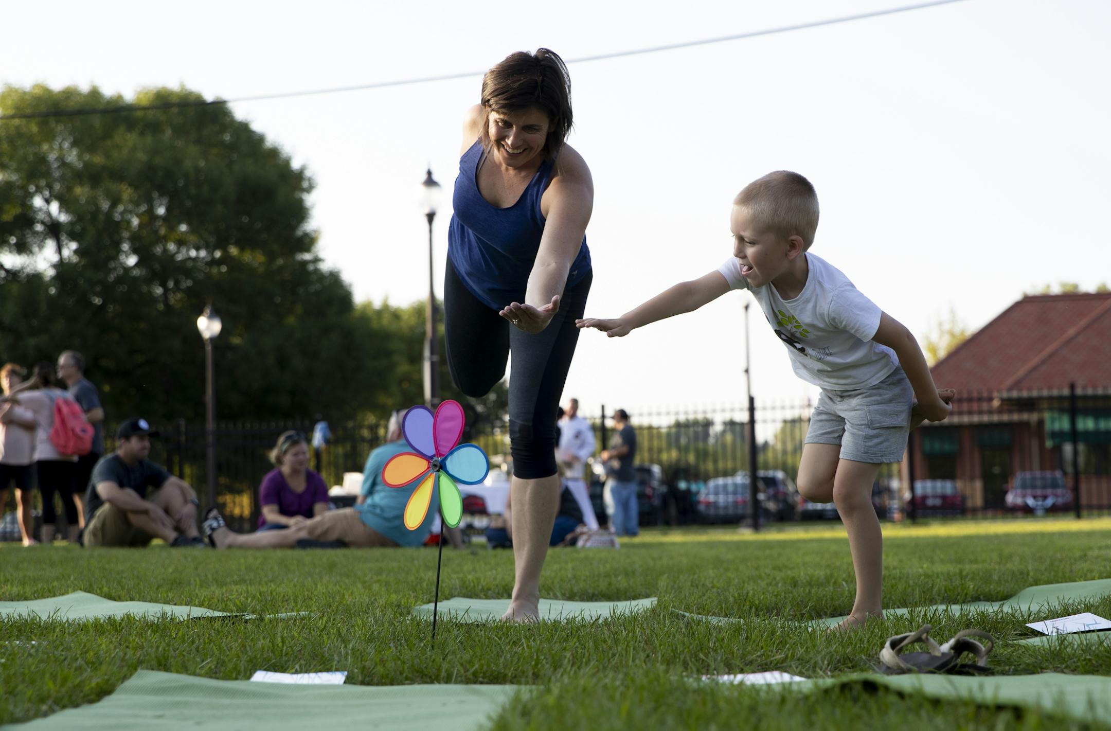 Maggie DeMars, of Be Your Best Yoga for Youth, taught Luke Davidson, 5, a yoga pose at the grand opening of the Virtues Trail in Faribault, Minn. on August 22, 2018. Faribault has launched a community-wide effort called the Virtues Project to help teach and incorporate virtues in everyday life -- in business, in schools, in sports. This was the grand opening of the Virtues Trail with mirrors with virtues written in three languages.