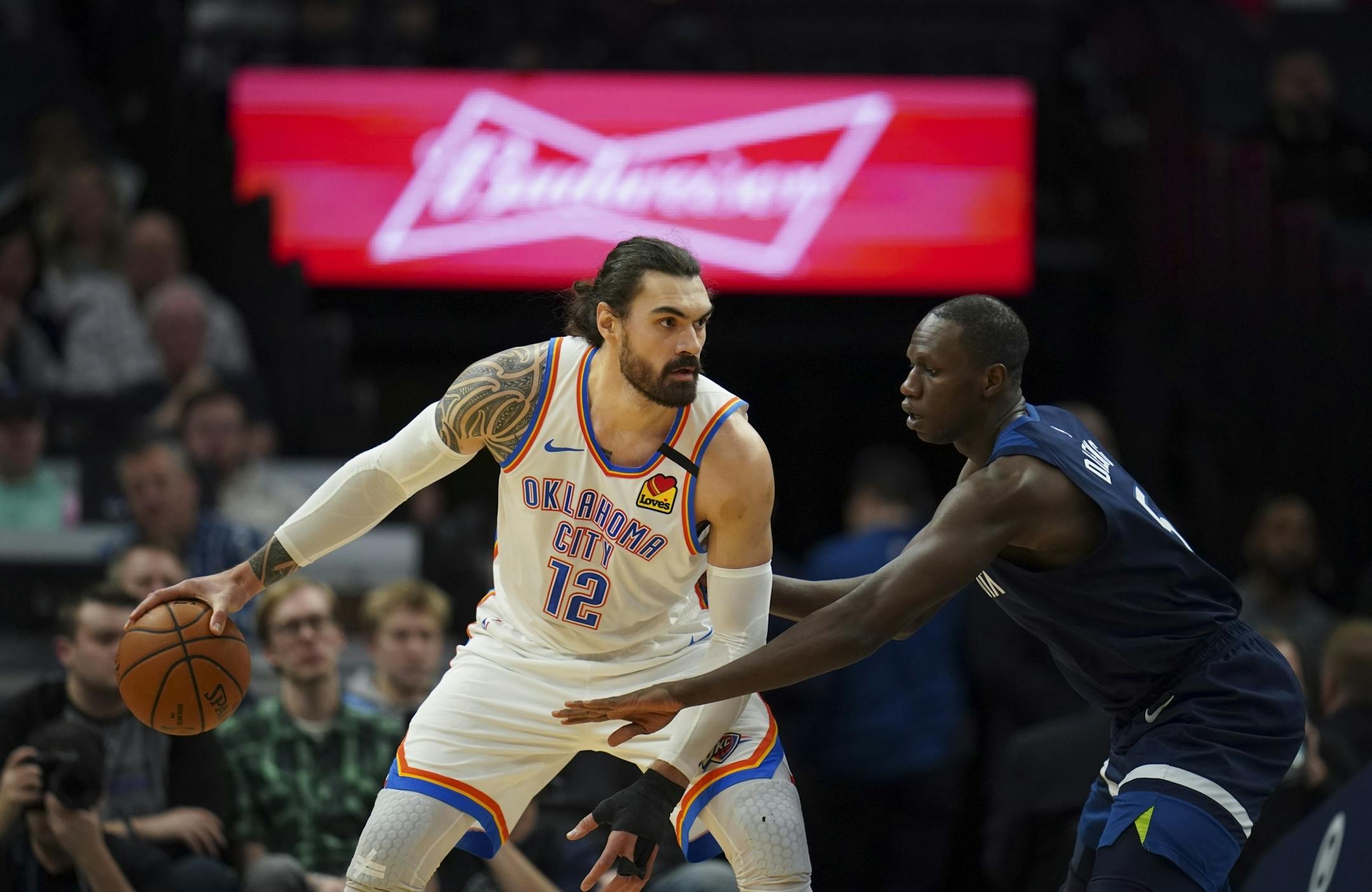 Oklahoma City Thunder center Steven Adams (12) held off Minnesota Timberwolves center Gorgui Dieng (5) while he looked for someone to pass to in the first quarter.