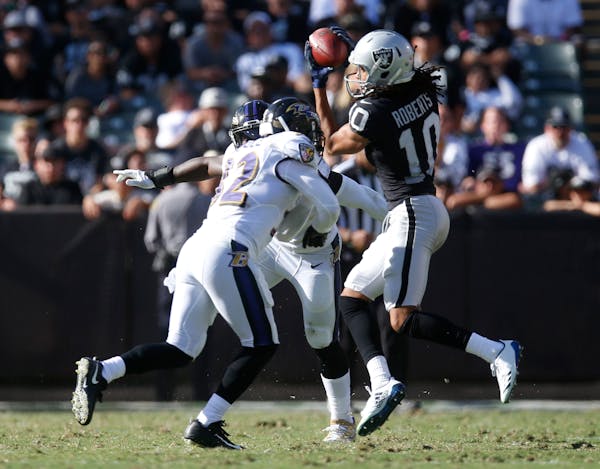 Oakland Raiders wide receiver Seth Roberts can't hold onto a catch against Baltimore Ravens safety Eric Weddle