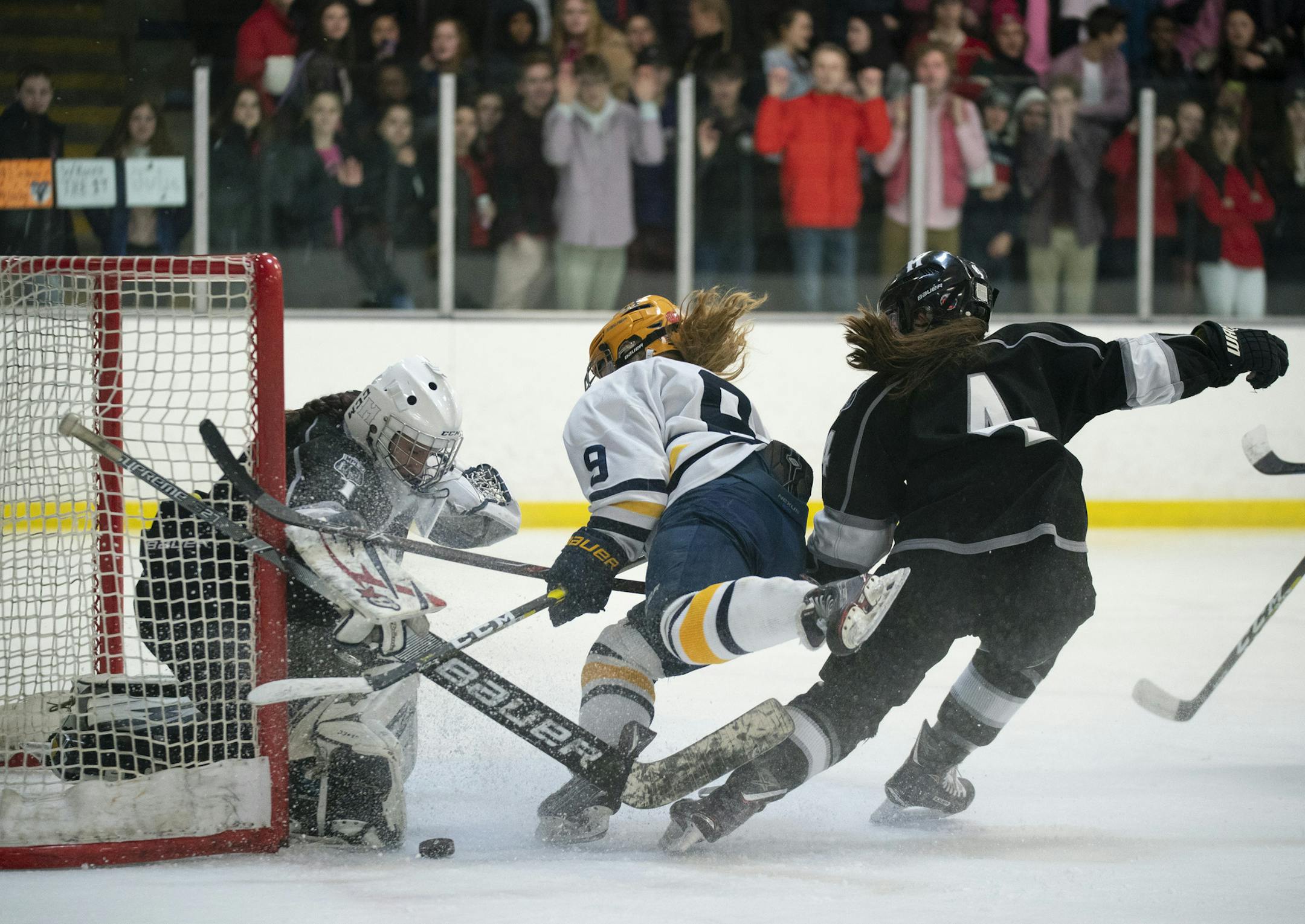 Minneapolis goaltender Maeve Tallman (1) stopped a shot by Breck forward Sadie Lindsay (8) while Minneapolis defenseman Lucy Pham (4) defended in the third period. ] JEFF WHEELER • jeff.wheeler@startribune.com Breck defeated Minneapolis 7-0 in their Class 1A, Section 5 girl's hockey playoff game Thursday night, February 14, 2019 at Parade Ice Garden in Minneapolis.