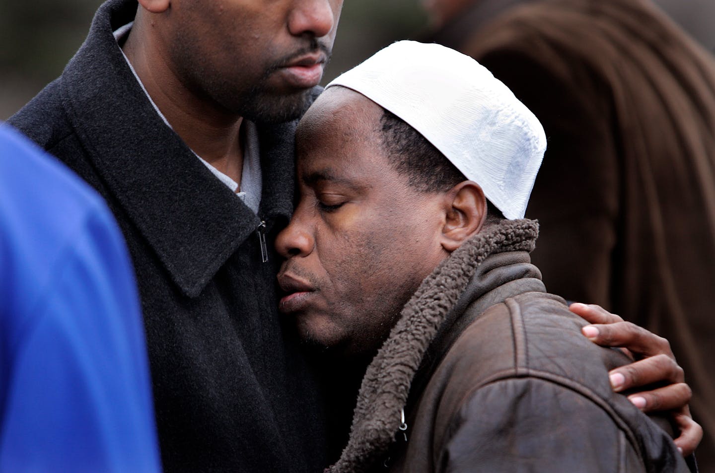 Osman Akubar, was consoled during his wife�s funeral at the Minnesota Islamic cemetery in Burnsville on Monday. Osman is the husband of Hanna Akubar who was killed by a 15-year-old boy fleeing police in a stolen sedan.