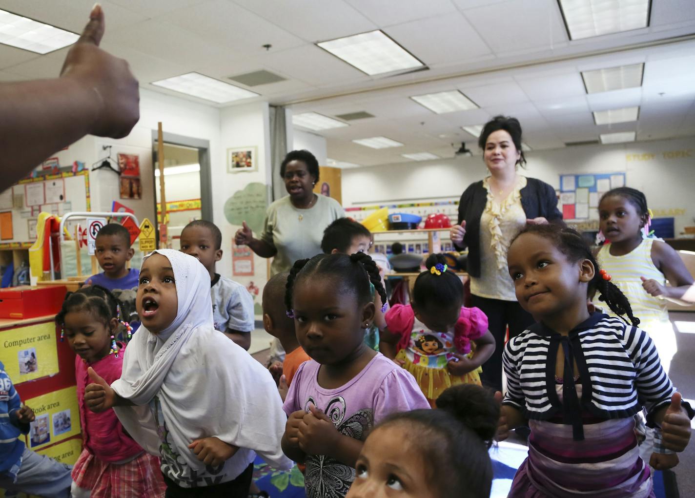 In Hennepin County, the Parents in Community Action (PICA) Head Start program will be forced to let up to 14 teachers go and kick 90 children out of classrooms for the 2014-15 school year if the sequester continues. Here, during a large group time music and dance 3 to 5 year-old head start students in Delet Crawford's class, left, mimic their teacher Thursday, June 13, 2013, in Minneapolis, MN.](DAVID JOLES/STARTRIBUNE) djoles@startribune.com In the months since the automatic federal budget cuts