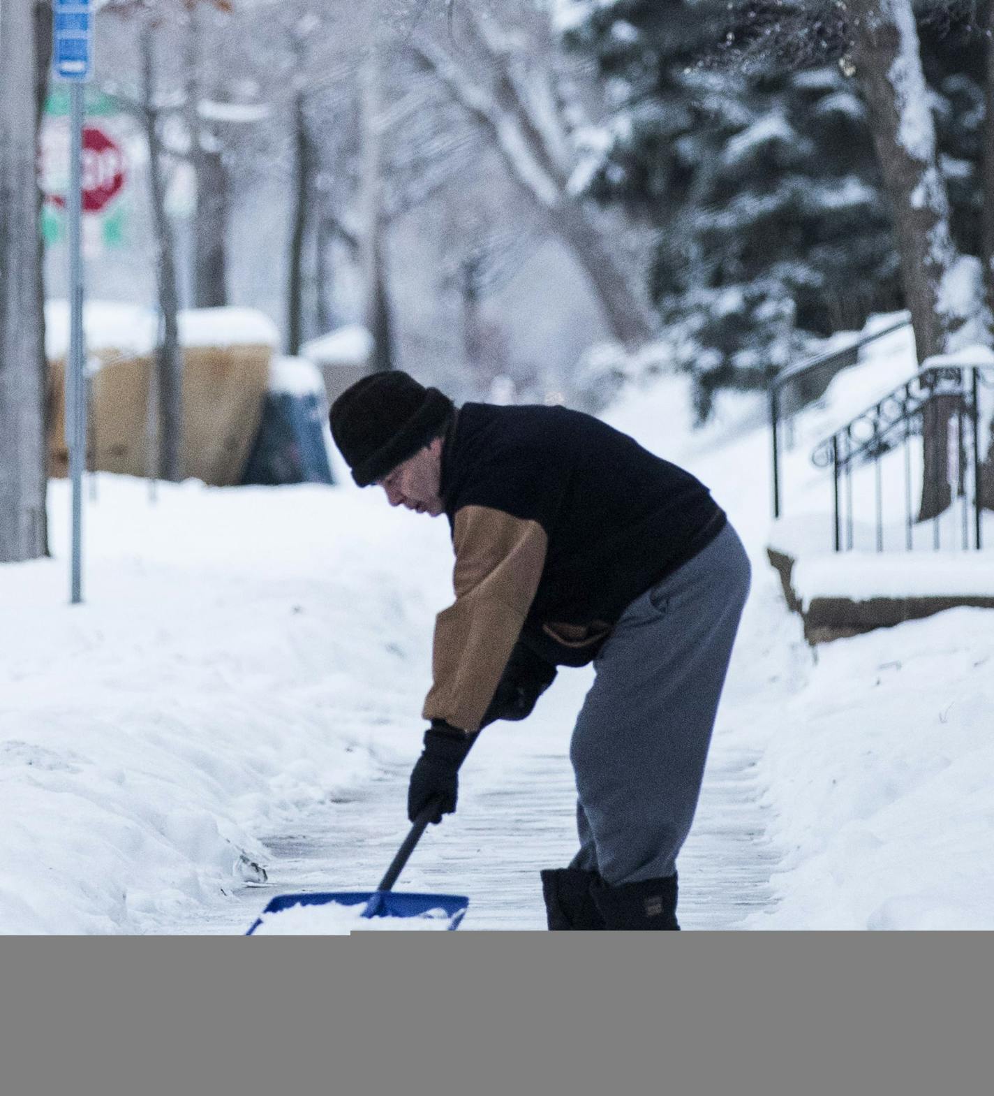 A man shovels the sidewalk on S. 8th Street near Riverside Avenue in Minneapolis. ] (Leila Navidi/Star Tribune) leila.navidi@startribune.com BACKGROUND INFORMATION: (NOTE - He did not want to give his name) Morning commute in Minneapolis after a weekend of snow on Monday, December 12, 2016. Minneapolis, St. Paul and a number of suburbs including West St. Paul, St. Louis Park and Plymouth declared snow emergencies late Sunday morning and into Monday.