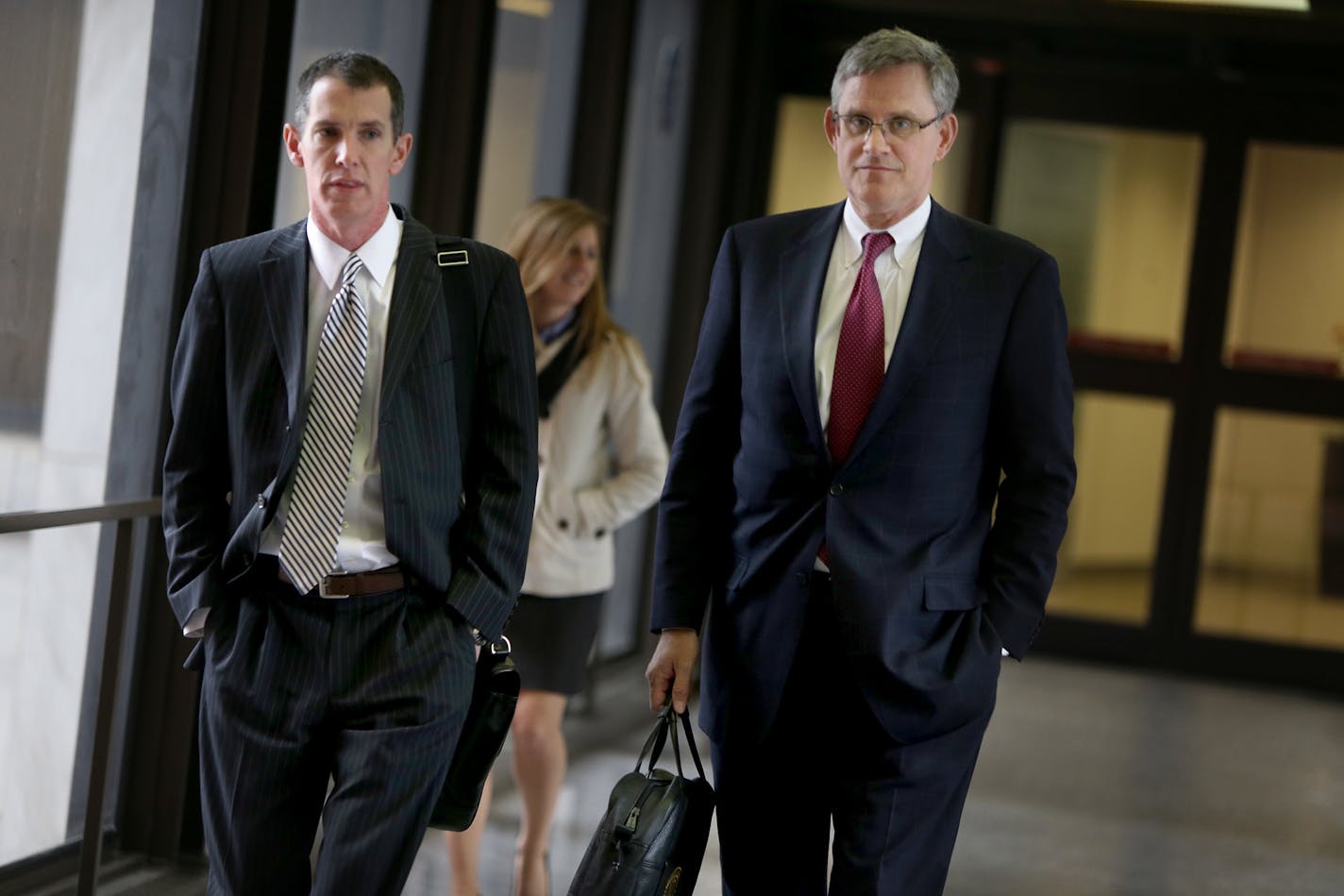 Chris Madel, left, and Paul Engh, right, the original Petters attorneys, made their way out of the Federal Courthouse during lunch break, Wednesday, October 23, 2013 in St. Paul, MN. They were there for a hearing on the motion by Tom Petters to reduce his sentence from 50 years to 30 years, based on a purported pre-trial plea offer by federal prosecutors. (ELIZABETH FLORES/STAR TRIBUNE) ELIZABETH FLORES � eflores@startribune.com