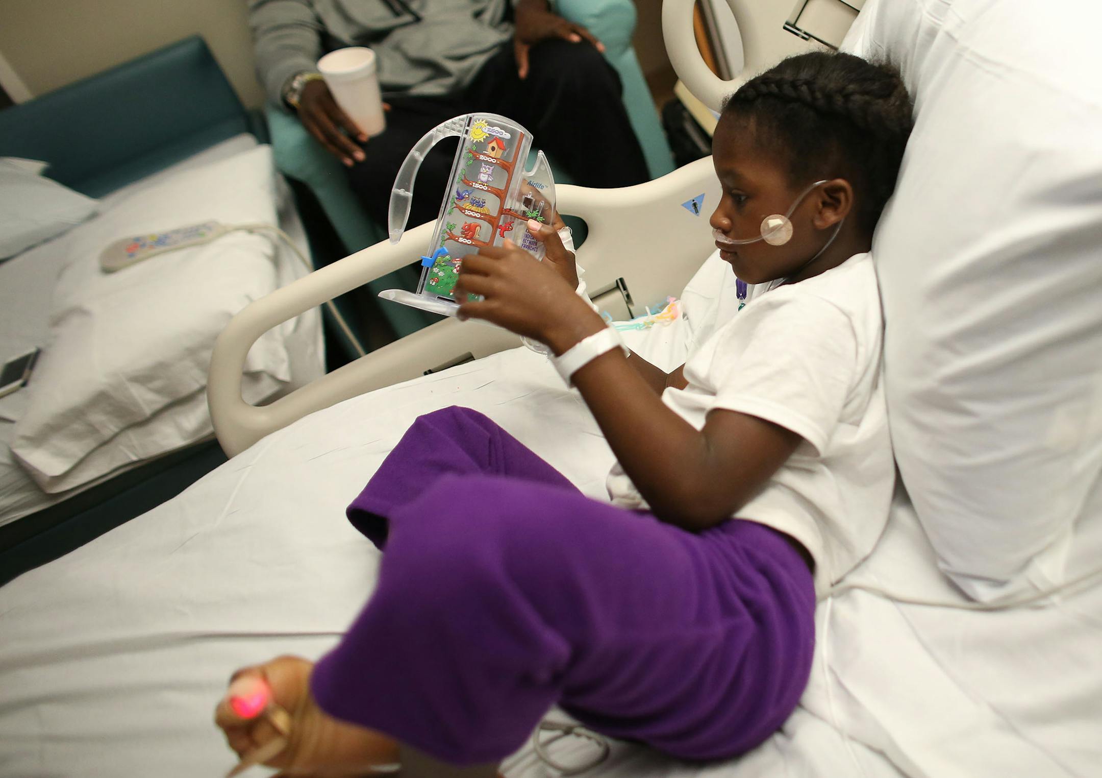 Kennedy Smith, 4, played with her incentive spirometer to help exercise her lungs as she recovers from her respiratory trouble. ] (KYNDELL HARKNESS/STAR TRIBUNE) kyndell.harkness@startribune.com At Children's Hospital in Minneapolis Min., Thursday, September 11, 2014.