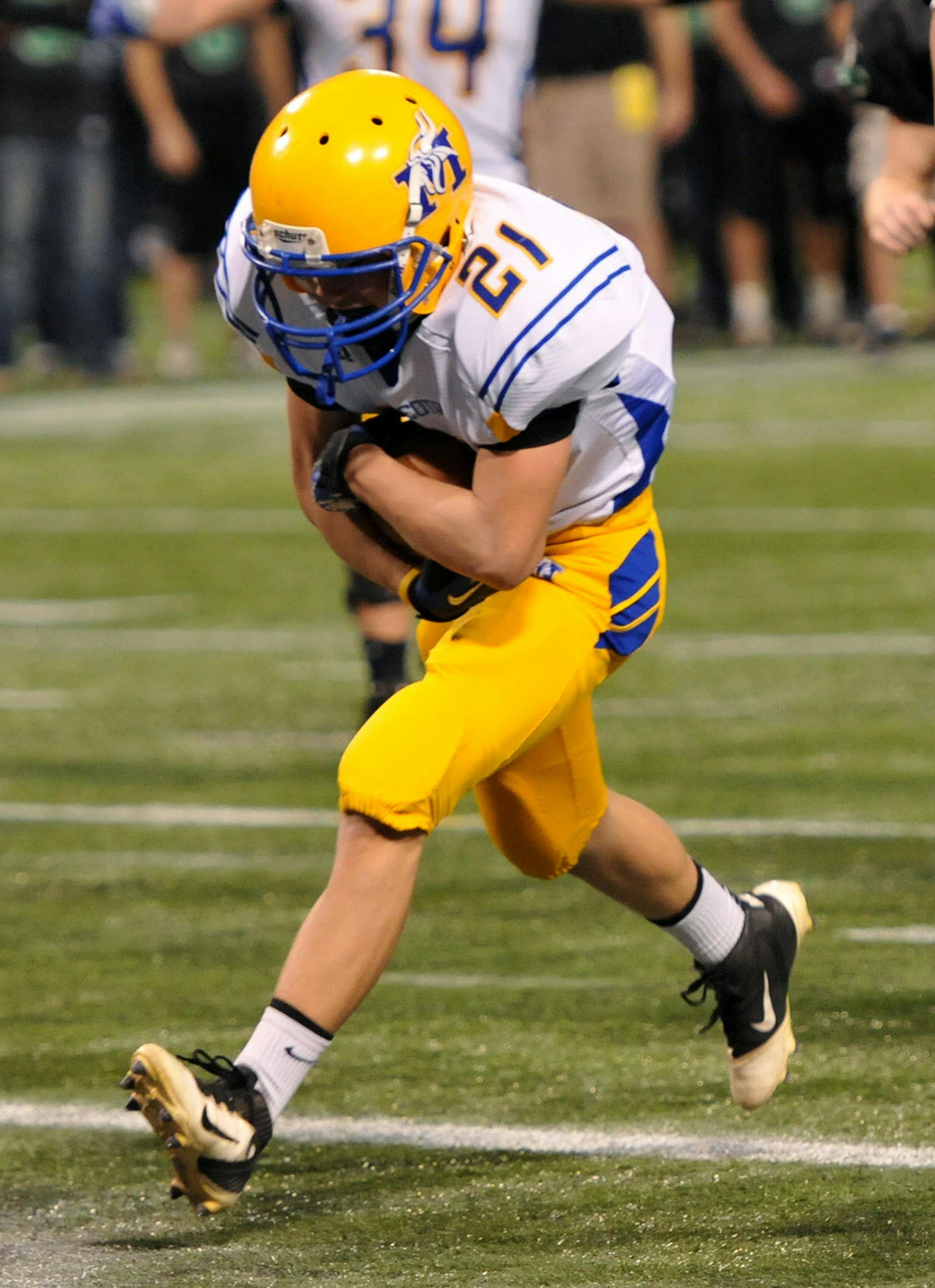 Minneota/Lincoln HI's Brock Buysse carries the ball into the end zone for the final Viking's touchdown of the second half of a Class 2A semifinal game Thursday at the Metrodome. Minneota/Lincoln HI 's 50-24 win over Maple Lake sends the Vikings to the Class 2A final November 29. ] (SPECIAL TO THE STAR TRIBUNE/BRE McGEE) **Brock Buysse (white, 21)
