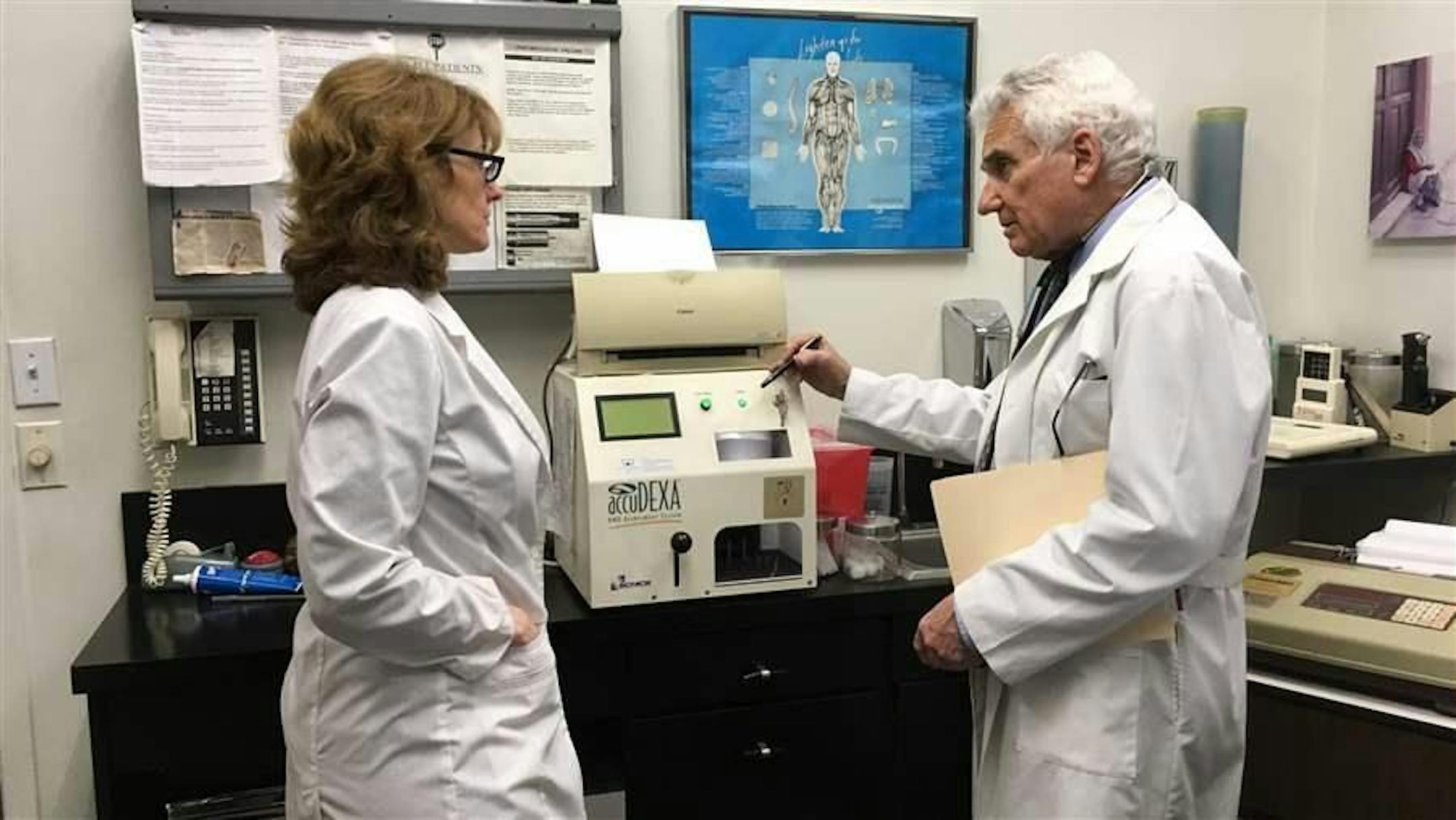Dr. Howard Shapiro discusses a patient's progress with assistant Alexandra Lotito at his midtown Manhattan office. Shapiro says marijuana shows promise as an alternative to opioid painkillers and other prescription drugs in treating a wide range of conditions.