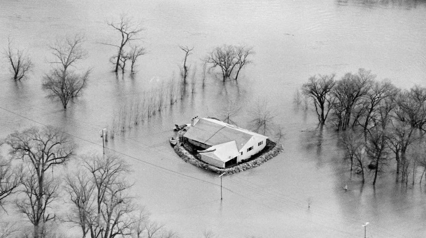 Frequent, costly floods have been the price of life along the Red River, as this scene from 1969 spring flood shows. The Army Corps of Engineers hopes the $2 billion Red River Diversion Project will spare Fargo in the future.