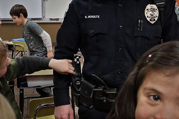 Curious students asked Jordan police officer Shane Schultz questions during a recent visit to Jordan Elementary school, where the Jordan Police Depart