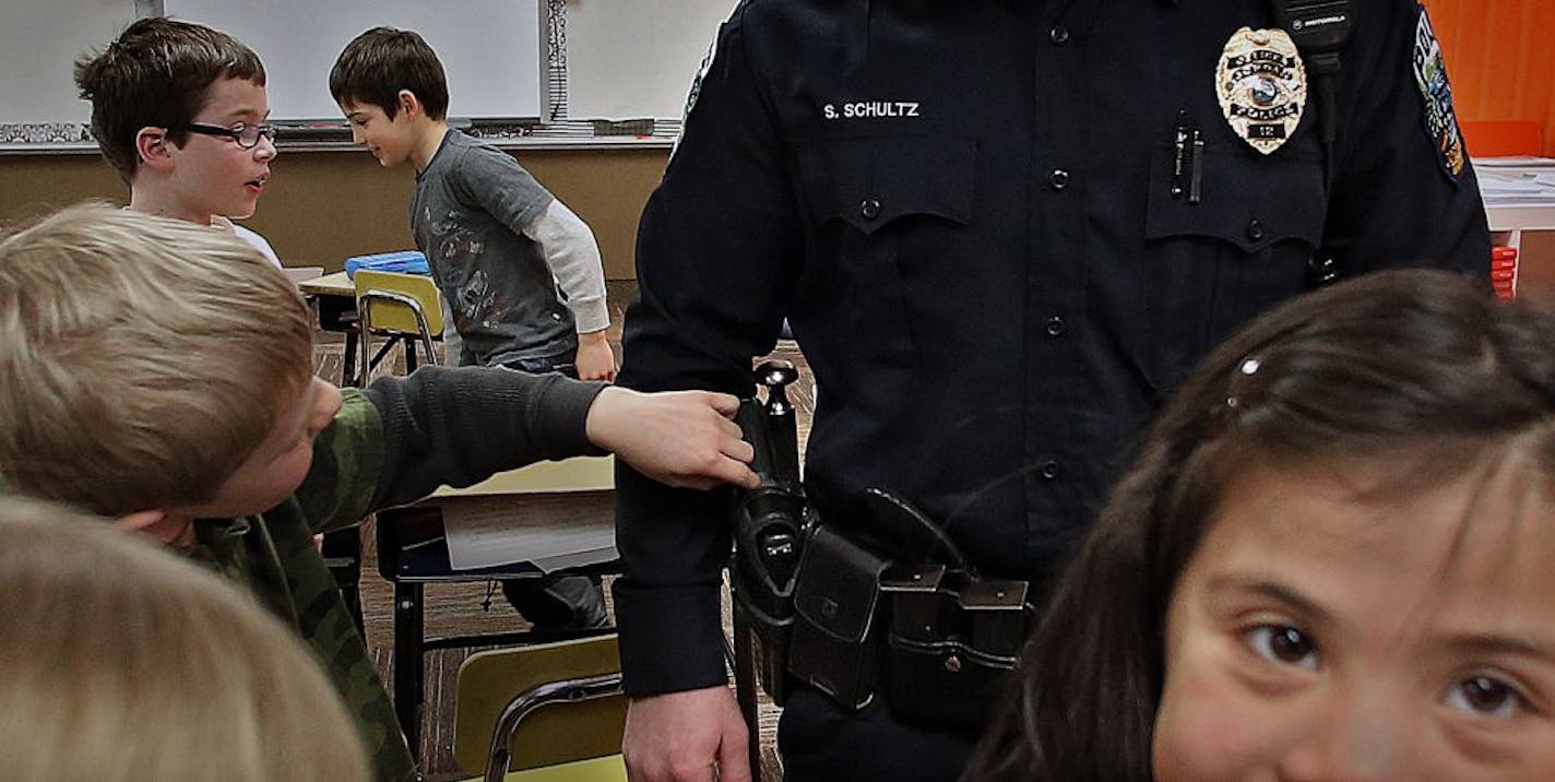 Curious students asked Jordan police officer Shane Schultz questions during a recent visit to Jordan Elementary school, where the Jordan Police Department will soon have one of their new offices.