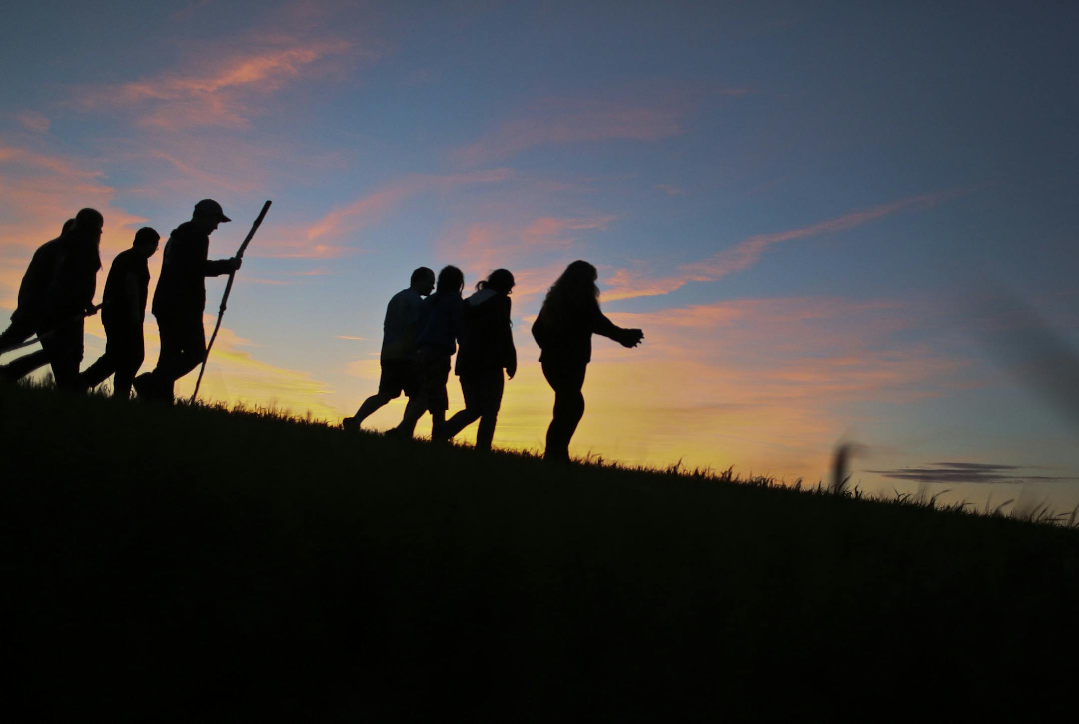 University of Minnesota students enrolled in a spring philosophy camp course walk toward the fading sun light on an impromptu prairie walk where topics discussed varied from neuroscience to intoxication Sunday, June 2, 2013, in Windom, MN.](DAVID JOLES/STARTRIBUNE) djoles@startribune.com A University of Minnesota philosophy camp takes place each spring on the rolling prairie of southwestern Minnesota where students and instructors form a community for living and learning to investigate their own