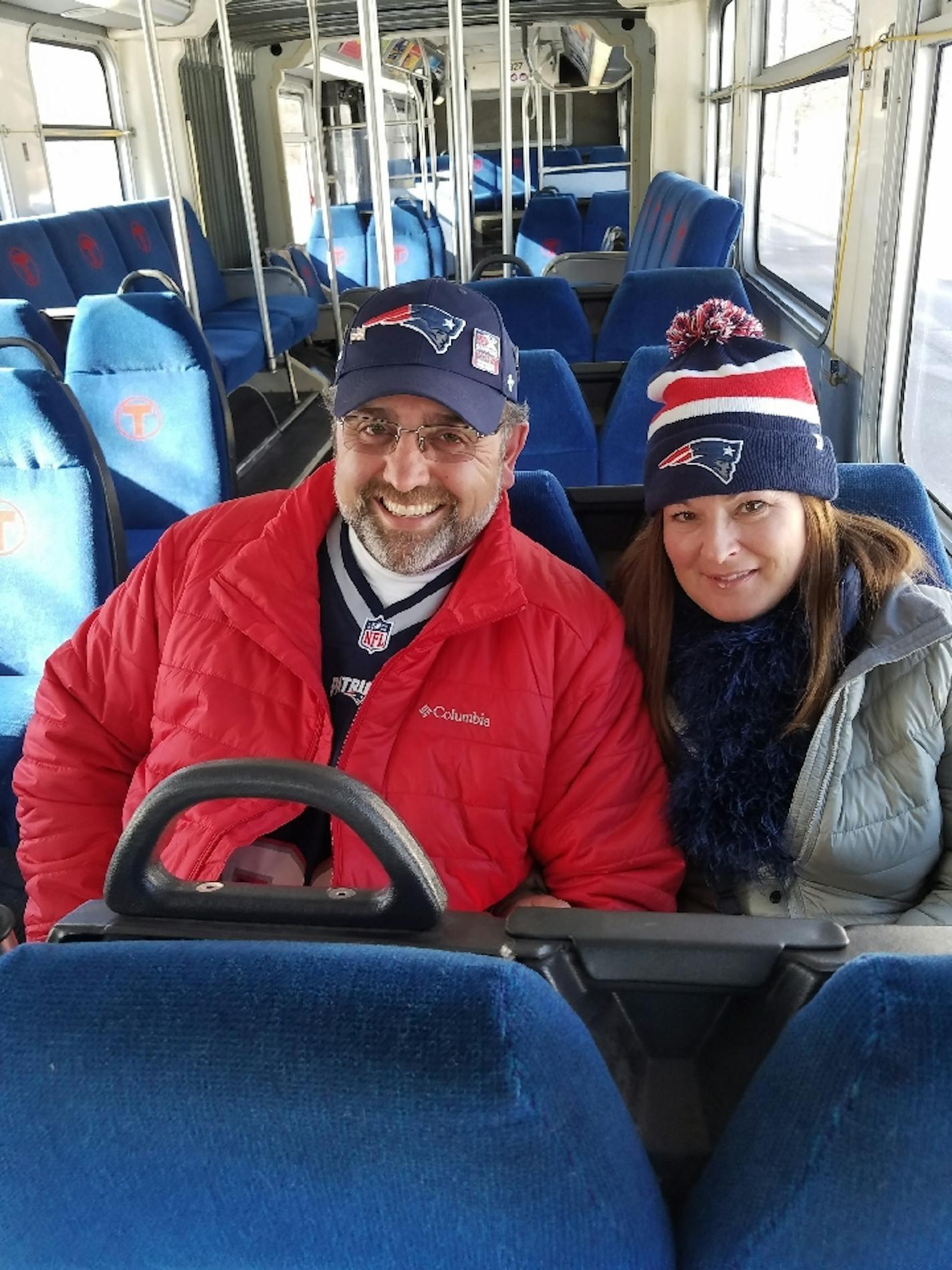 Patriots fans Kerry and Wendell Orton of Florida had a replacement bus all to themselves while the light rail was used by fans traveling to the Super Bowl. (Photo by Tim Harlow)