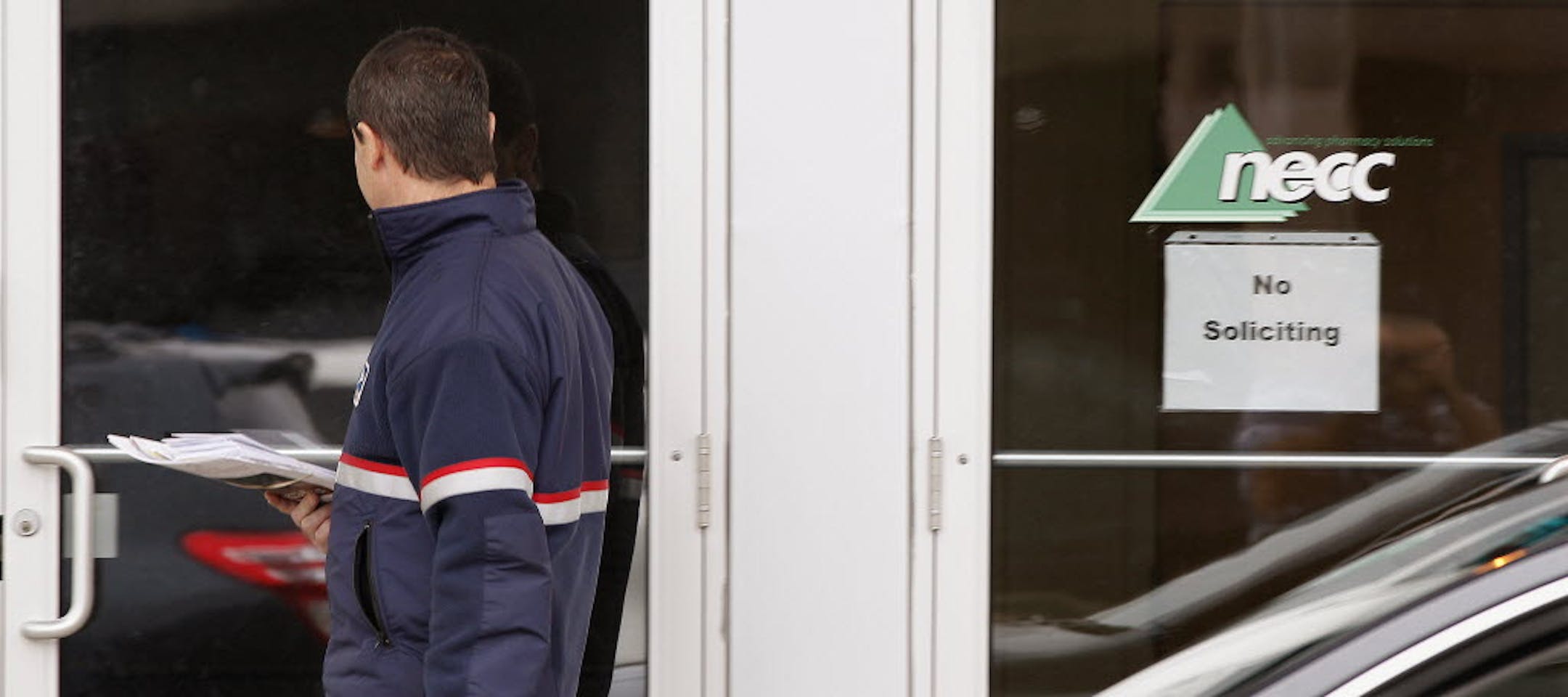 A delivery man walks up to the door of New England Compounding in Framingham, Mass. An outbreak of a rare and deadly form of fungal meningitis is believed to have been traced back to a steroid manufactured by the New England Compounding Center.