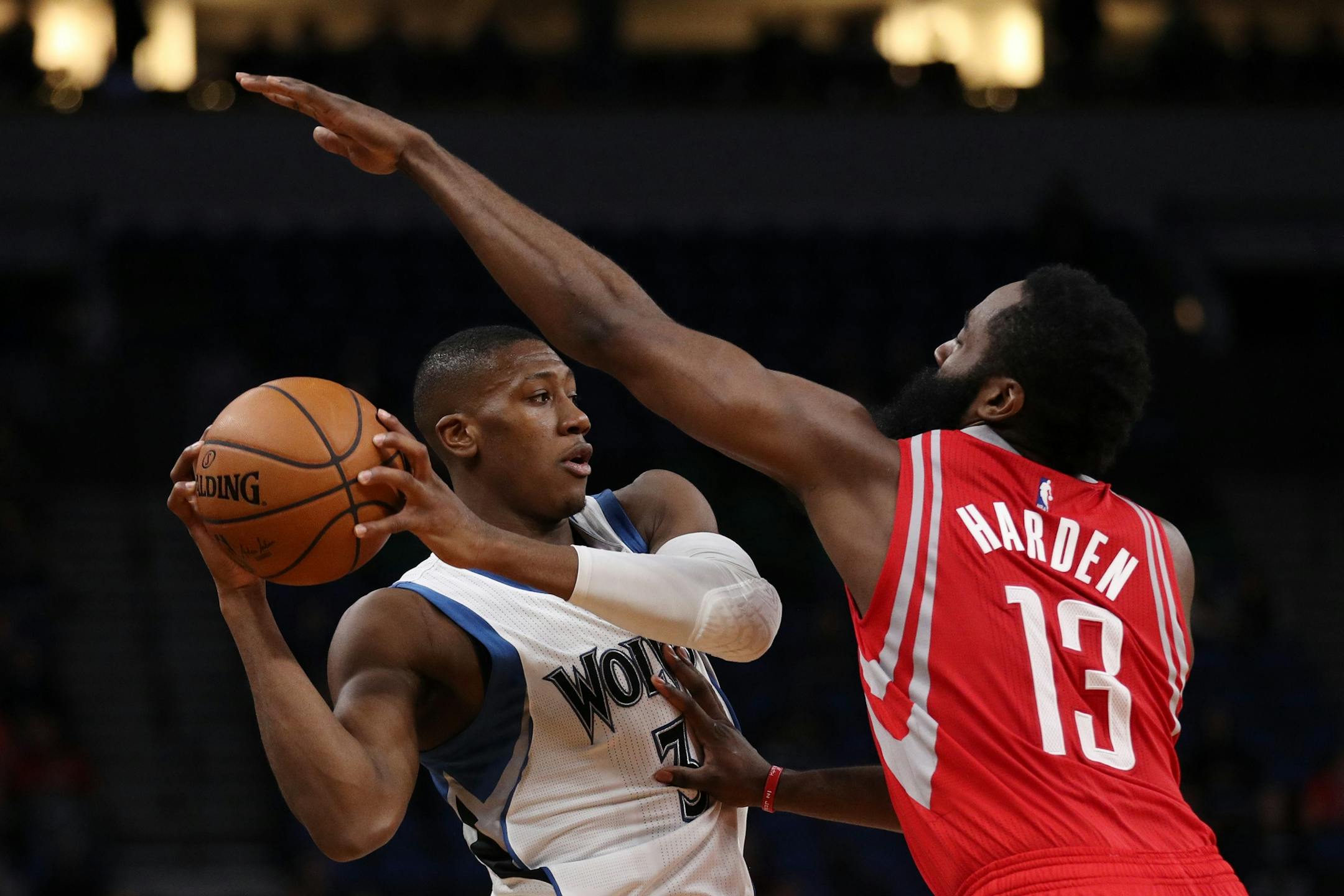 Minnesota Timberwolves guard Kris Dunn (3) looks to pass around Houston Rockets guard James Harden (13) in the first half.