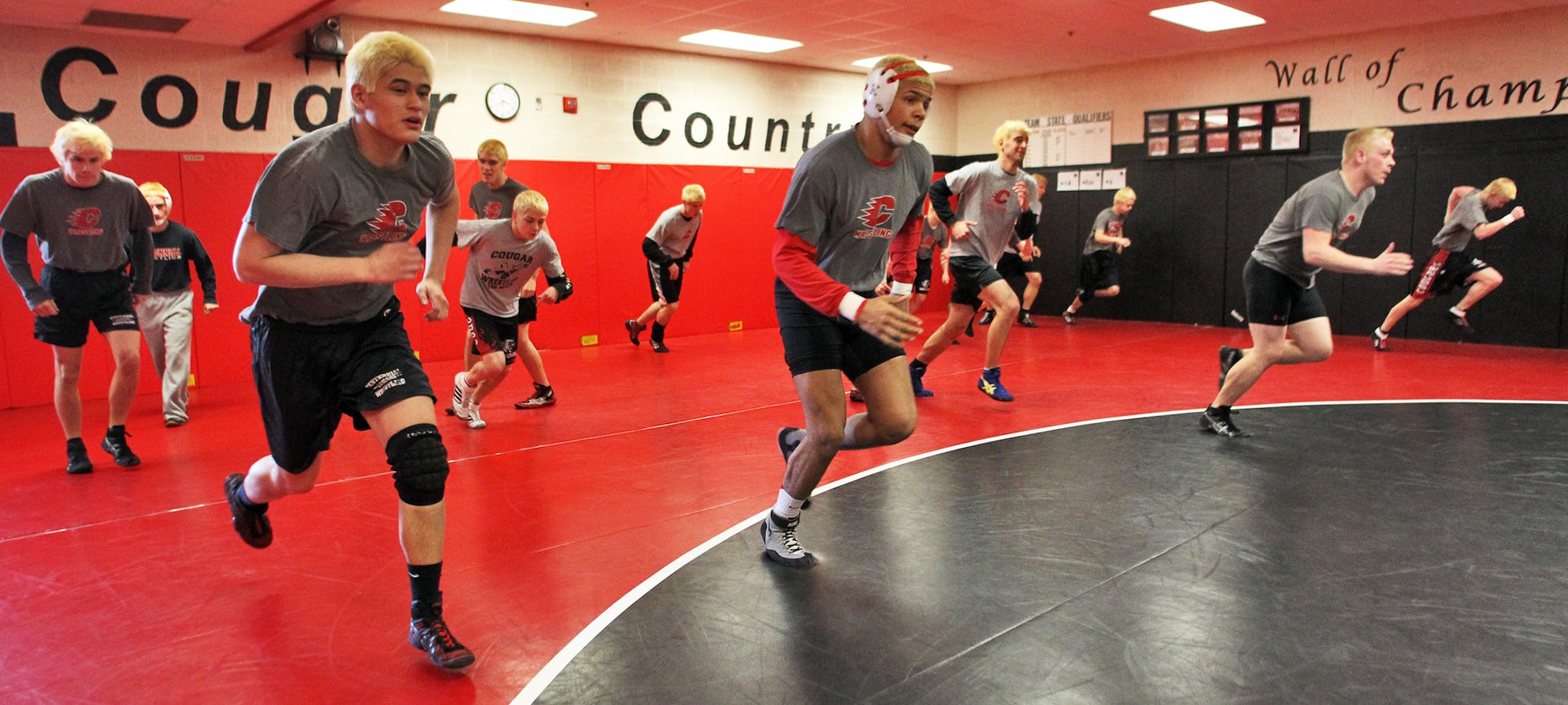 The recently blond-dyed members of the Centennial wrestling team ran wind sprints during practice in preparation for the state meet this week in St. Paul.