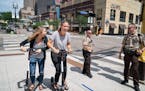 Sophie Konewko, left, and Megan Albers decided to take two Bird scooters for a ride through downtown Minneapolis after lunch Tuesday.