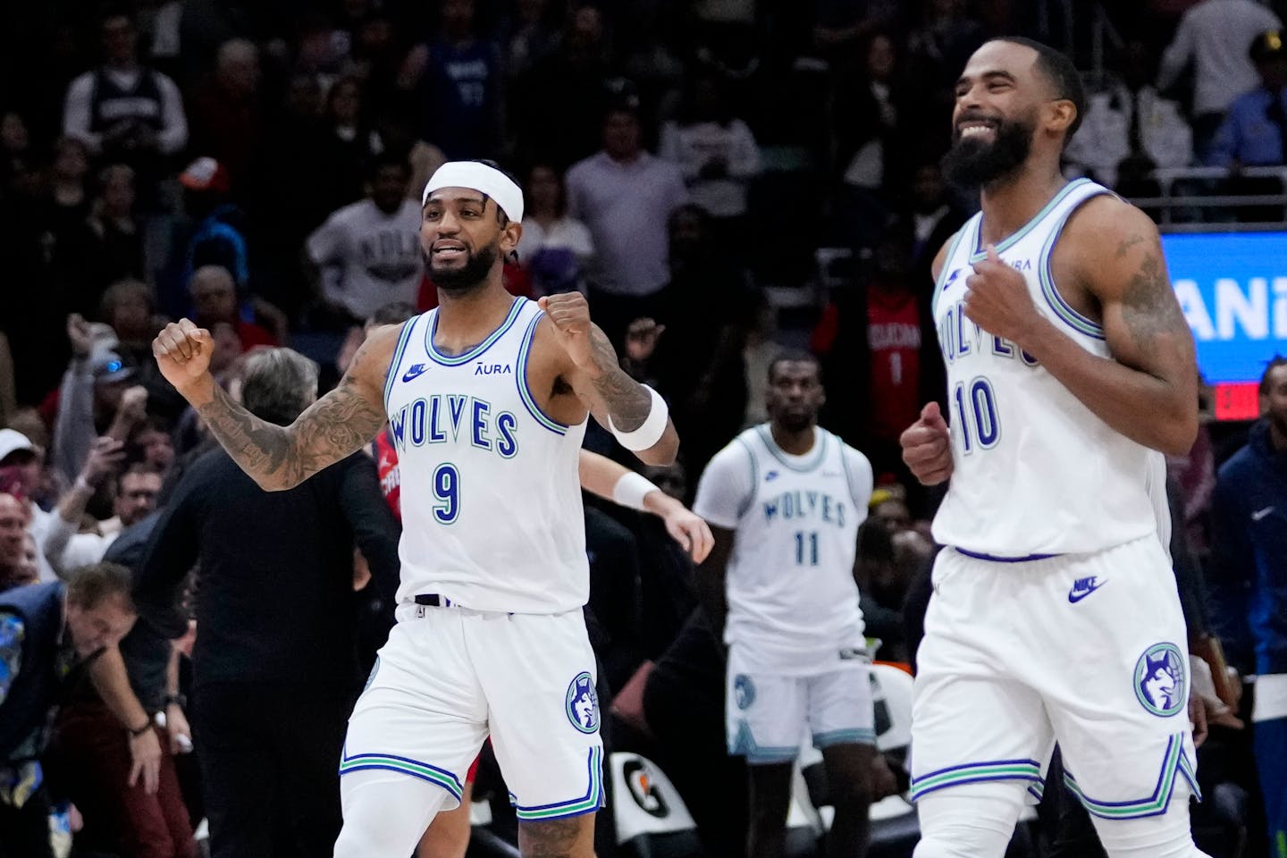 Minnesota Timberwolves guard Nickeil Alexander-Walker (9) and guard Mike Conley (10) celebrate after defeating the New Orleans Pelicans in an NBA basketball game in New Orleans, Saturday, Nov. 18, 2023. The Timberwolves won 121-120. (AP Photo/Gerald Herbert)