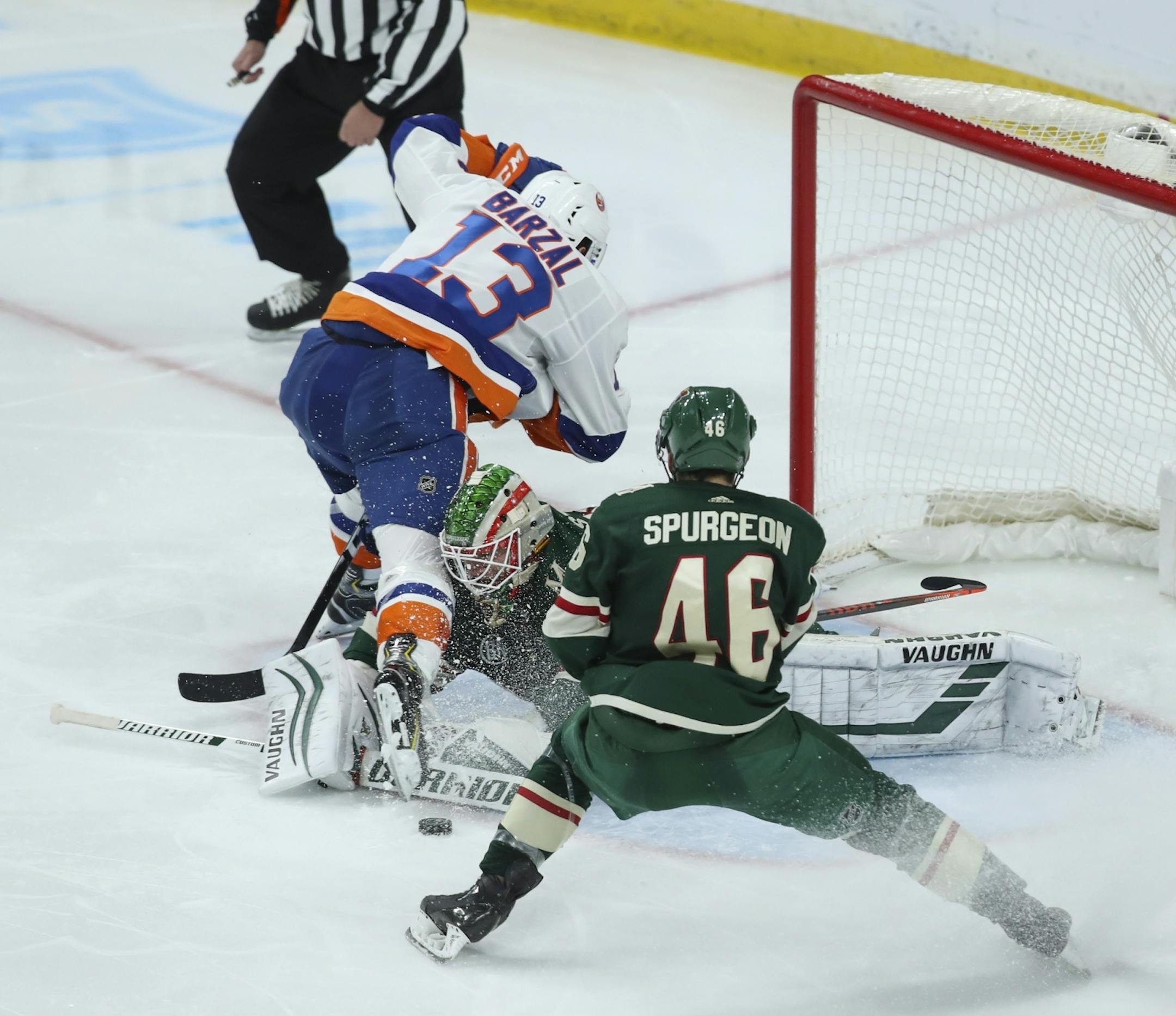 Minnesota Wild goaltender Alex Stalock (32) stopped New York Islanders center Mathew Barzal (13) when he had a third period breakaway. He was pursued by Minnesota Wild defenseman Jared Spurgeon