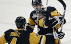 Pittsburgh Penguins' Bryan Rust, center, celebrates his goal against the San Jose Sharks with Justin Schultz (4) and Evgeni Malkin, rear, during the f