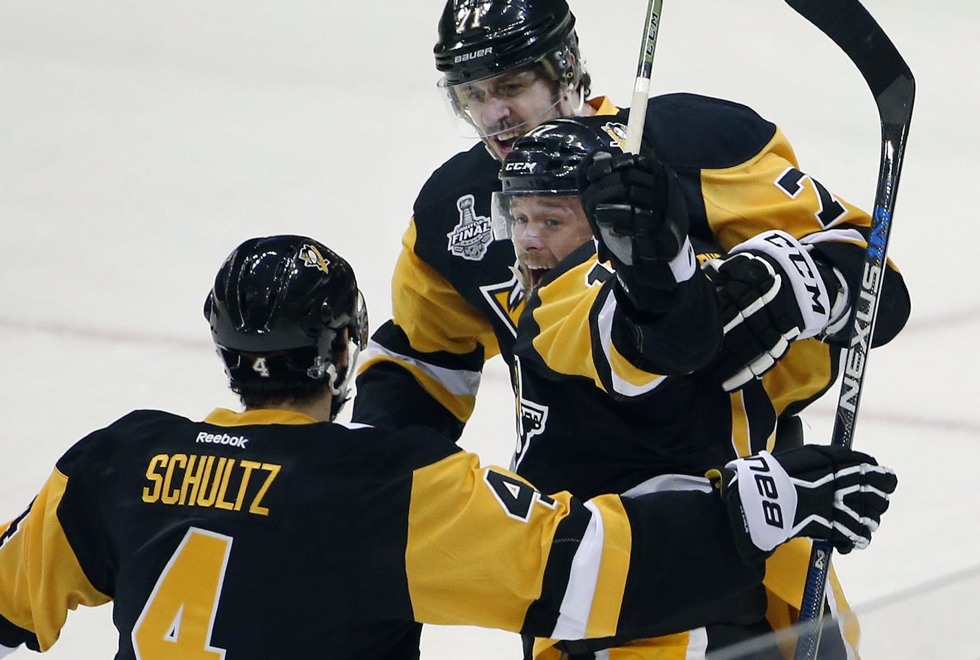 Pittsburgh Penguins' Bryan Rust, center, celebrates his goal against the San Jose Sharks with Justin Schultz (4) and Evgeni Malkin, rear, during the first period in Game 1 of the Stanley Cup final series Monday, May 30, 2016, in Pittsburgh. (AP Photo/Gene J. Puskar)