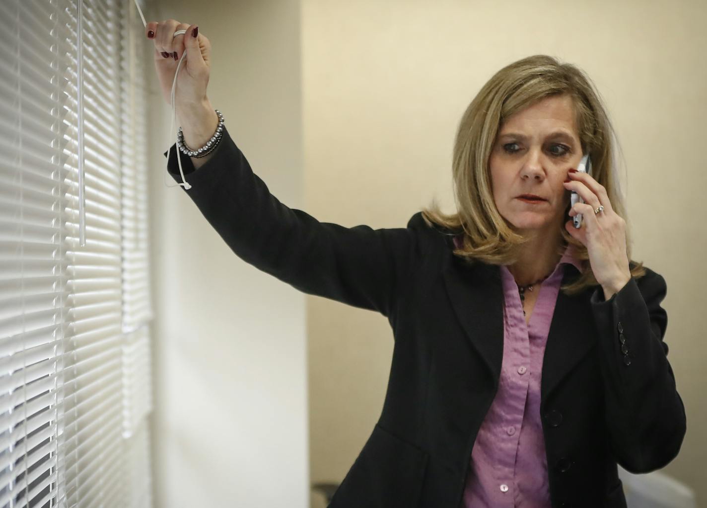 Jennifer DeCubellis talked on her phone before a "rapid huddle" meeting with other county staff to review where they're at in putting together Hennepin County's huge $13 million reform of its child protection system at the Hennepin County Government Center on Monday, March 20, 2017, in Minneapolis, Minn. ] RENEE JONES SCHNEIDER &#x2022; renee.jones@startribune.com