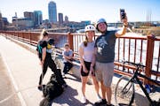 Sonya Hesse and Silvio Pardron take a selfie together on the Stone Arch Bridge on Sunday, the final day before half the bridge closes for construction