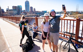 Sonya Hesse and Silvio Pardron take a selfie together on the Stone Arch Bridge on Sunday, the final day before half the bridge closes for construction