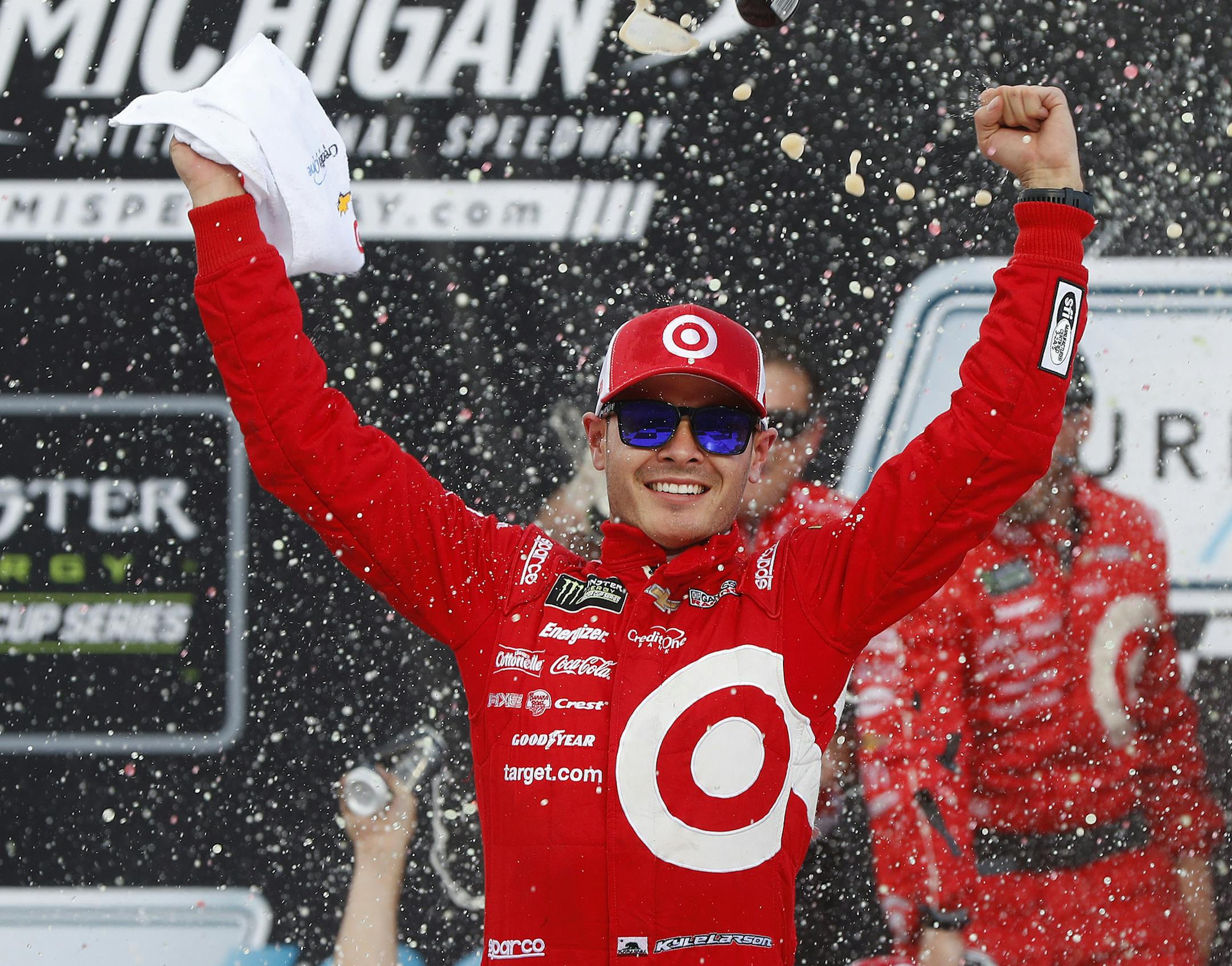 Kyle Larson celebrates winning the NASCAR Cup Series auto race in Brooklyn, Mich., Sunday, Aug. 13, 2017. (AP Photo/Paul Sancya)