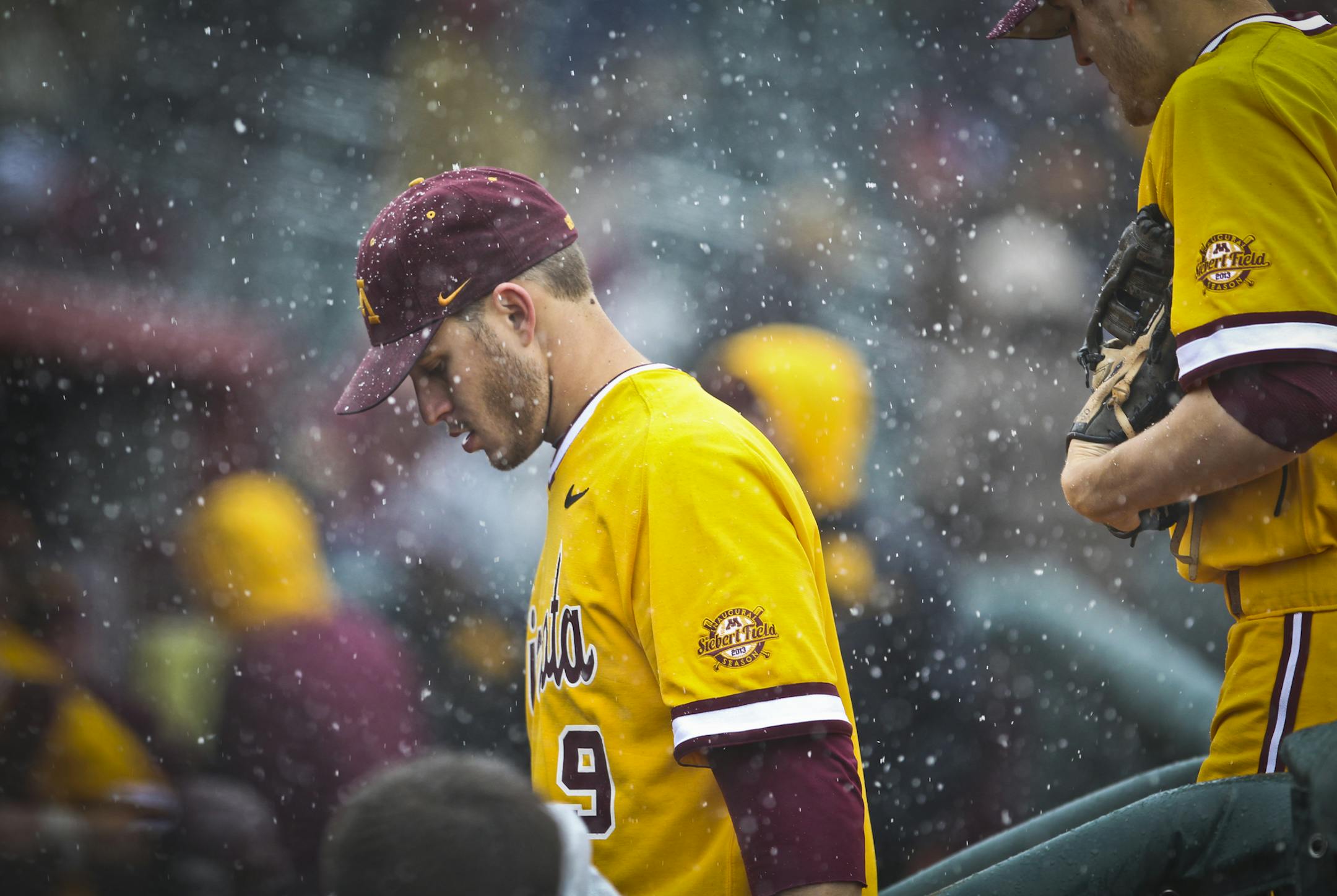 Gopher’s Michael Handel walked off the field during a snow delay (officials eventually called the game) on opening day at the new Siebert Field in Minneapolis