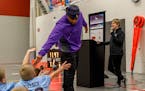 Former Minnesota Vikings linebacker E.J. Henderson visited schoolchildren in Worthington, where $60,000 in Super Bowl legacy grants were awarded.