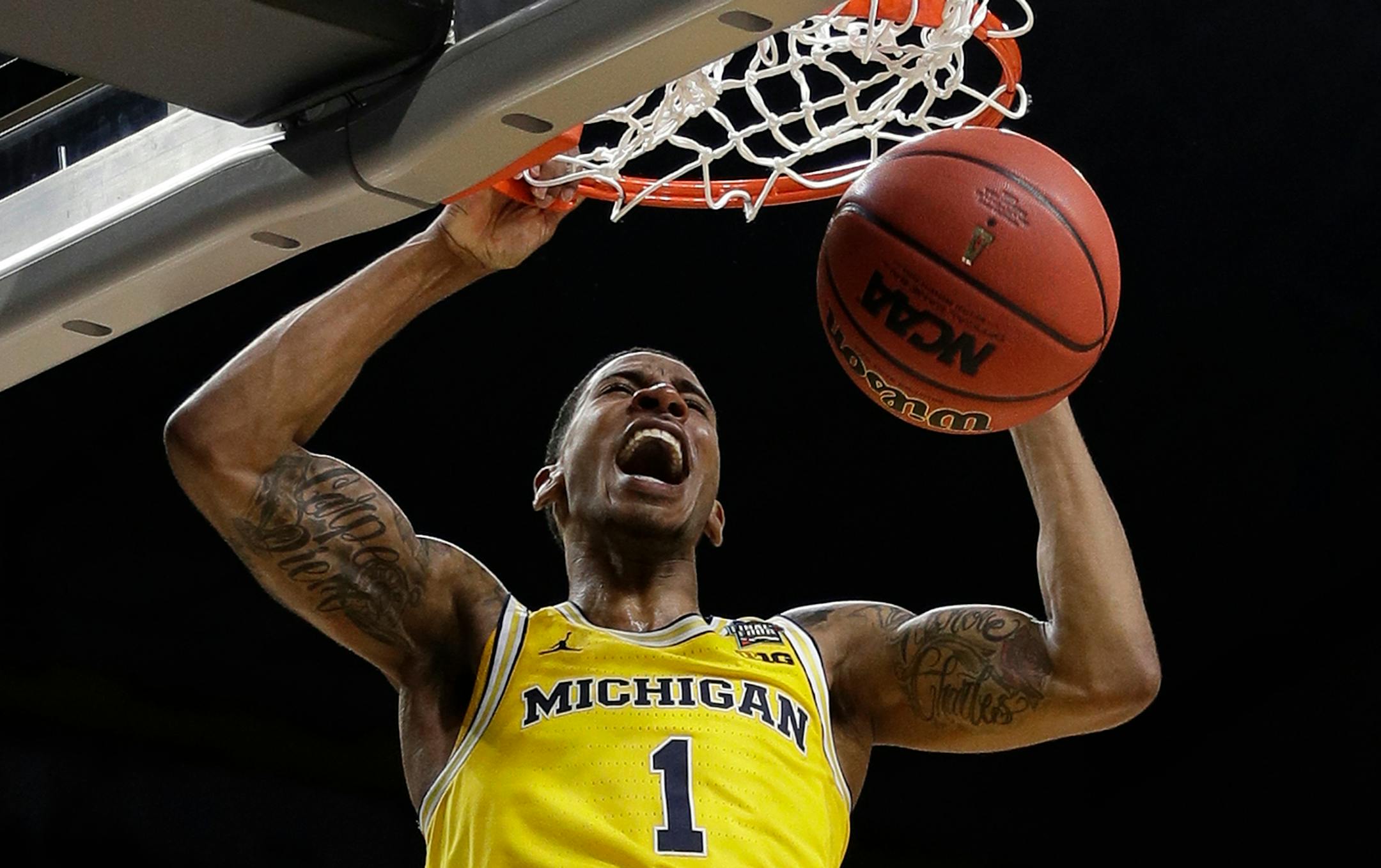 Michigan's Charles Matthews (1) dunks during the second half in the semifinals of the Final Four NCAA college basketball tournament against Loyola-Chicago, Saturday, March 31, 2018, in San Antonio. (AP Photo/David J. Phillip)