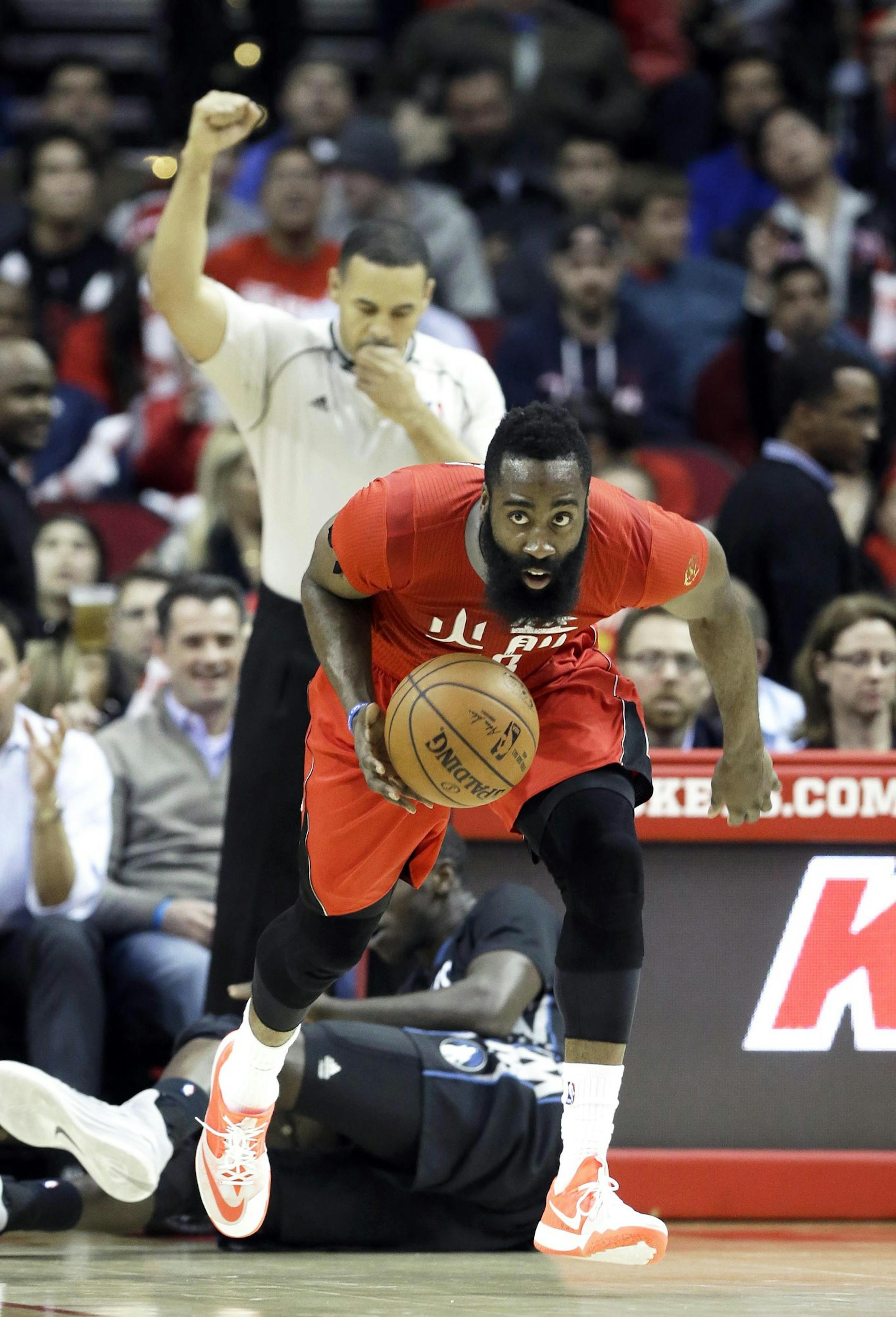 Houston Rockets' James Harden, right, heads up court against the Minnesota Timberwolves as referee Curtis Blair signals in the second half of an NBA basketball game Monday, Feb. 23, 2015, in Houston. Harden posted a triple double with 31 points, 11 rebounds and 10 assists. The Rockets won 113-102. (AP Photo/Pat Sullivan)