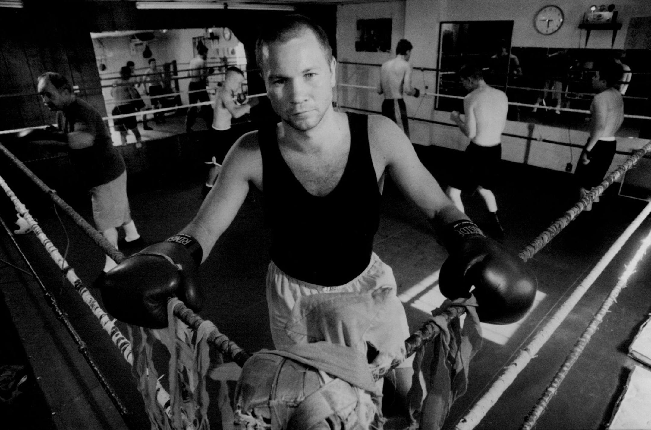 July 31, 1993 St. Paul boxer Mike Evgen in the ring at white bear golden gloves boxing club. Working out behind Evgen are coaches and young boxing students hopeful of fighting their way to the status that Evgen recently enjoyed in the ring. Evgen was recently released from hospital care after suffering brain seizures. He is battling health problems and is unsure of how aggressively he should pursue his boxing career. Mike Evgen, who is suffering from brain inflammation and whose personal life is