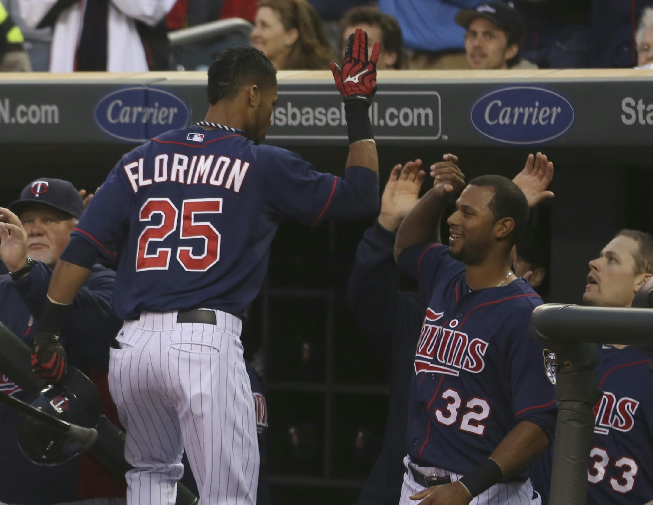Pedro Florimon celebrated with teammates after hitting a two-run home run during the third inning at Target Field on Friday.