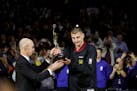 Nikola Jokic of the Nuggets got the NBA MVP trophy from Commissioner Adam Silver before Tuesday night's game against the Wolves, then went out and pla