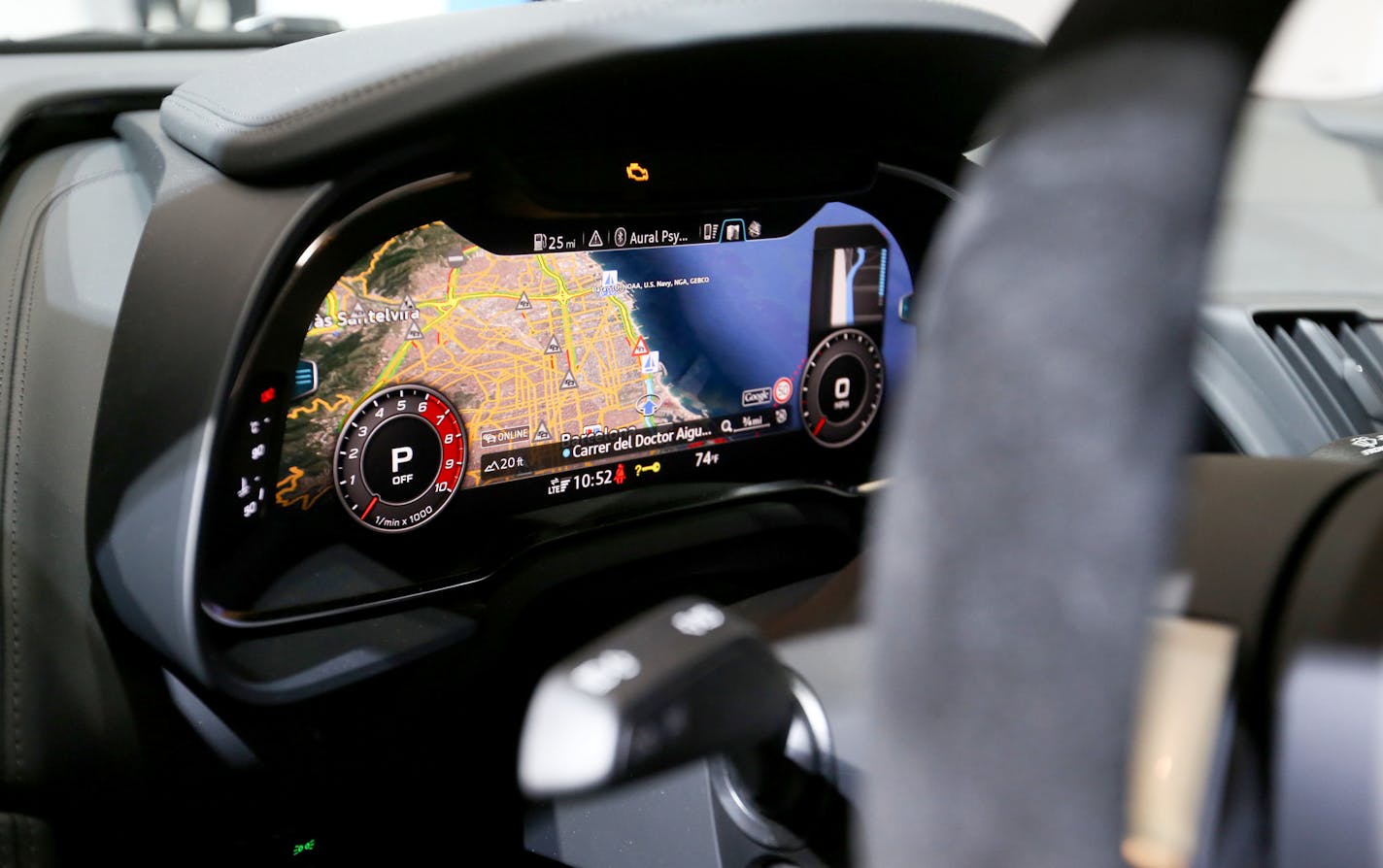 A map sits on a dashboard display of an Audi R8 V10 at the Mobile World Congress in Barcelona, Spain, on Monday. Carmakers are becoming a familiar sight at tech shows, where they're rolling out new models to woo a generation of consumers who question the need for a car that only gets them from A to B. MUST CREDIT: Bloomberg photo by Chris Ratcliffe.