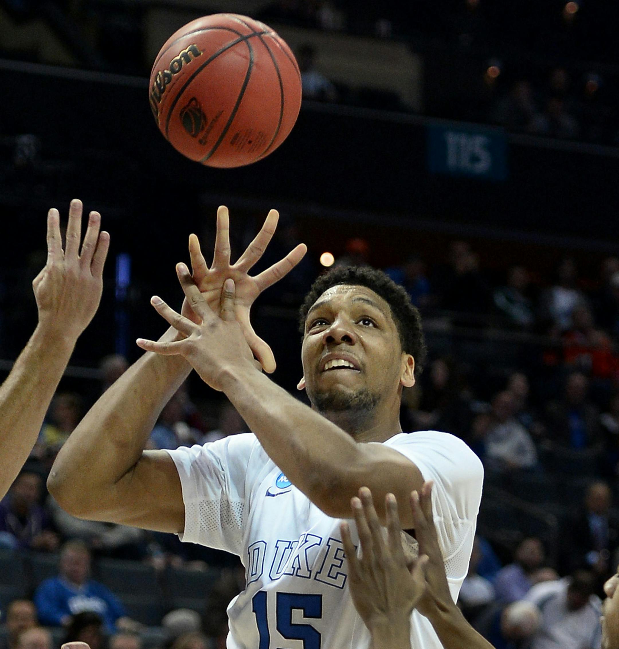 Duke's Jahlil Okafor (15) looks to regain control of a bobbled ball as Robert Morris' Robert Morris' Aaron Tate (24) and Marcquise Reed (2) apply defensive pressure in the second round of the NCAA Tournament at Time Warner Cable Arena in Charlotte, N.C., on Friday, March 20, 2015. (Jeff Siner/Charlotte Observer/TNS) ORG XMIT: 1165580