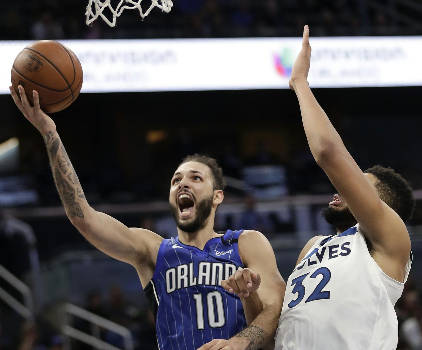 Orlando Magic's Evan Fournier (10) gets past Minnesota Timberwolves' Karl-Anthony Towns (32) for a shot during the second half of an NBA basketball game, Tuesday, Jan. 16, 2018, in Orlando, Fla. Orlando won 108-102. (AP Photo/John Raoux)