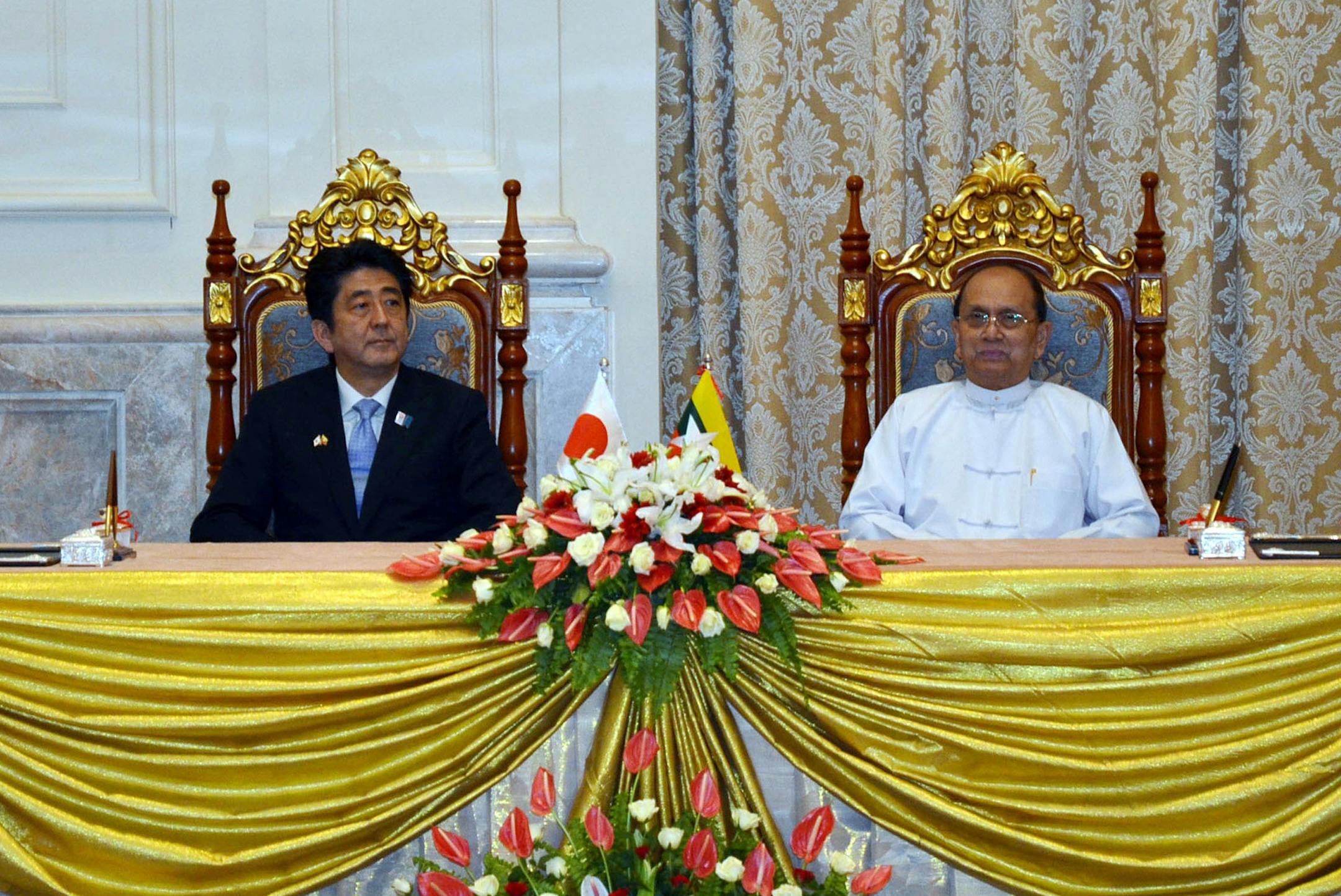 Myanmar President Thein Sein, right, and Japanese Prime Minister Shinzo Abe attend a signing ceremony at Presidential Palace Sunday, May 26, 2013, in Naypyitaw, Myanmar. Abe arrived in Myanmar on last Friday on the first visit to the country by a Japanese leader in 36 years, as Tokyo bids to reassert its position as a top economic partner after decades of frosty relations with the previous military regime. (AP Photo) ORG XMIT: MIN2013060314555847