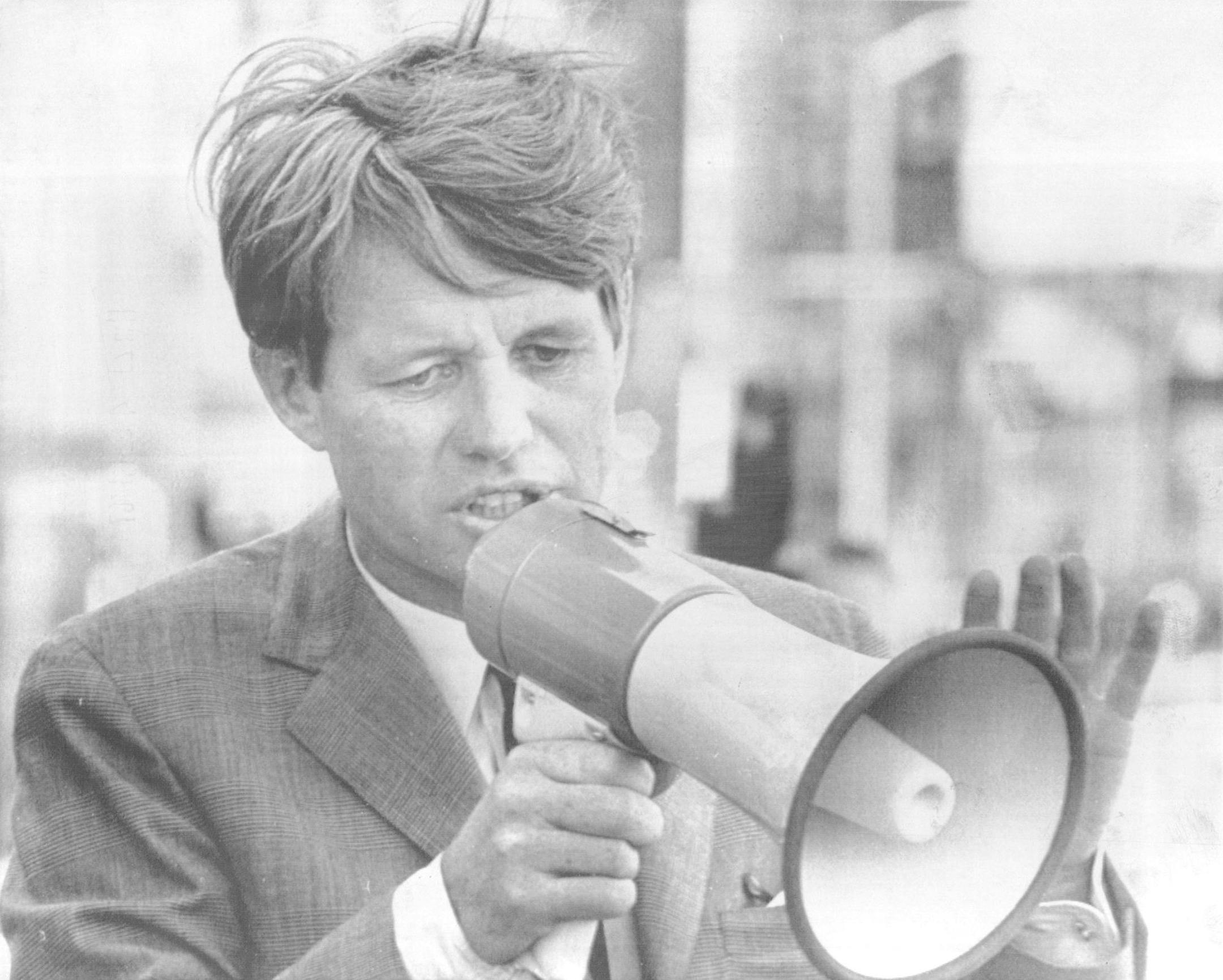 March 29, 1968 ROBERT F, KENNED IN DENVER He used bullhorn to bolster a failing voice Robert F. Kennedy of New York fought his way Thursday night through a screaming crowd to enter his candidacy in the May 7 Indiana presidential primary. The screaming began when Kennedy left his plane at Weir Cook Airport. The terminal was packed as he, his wife, Ethel, and his daughter, Kathleen, 16, fought their way through the surging crowd to their motorcade. THEY DROVE to downtown Indianapolis, where a larg