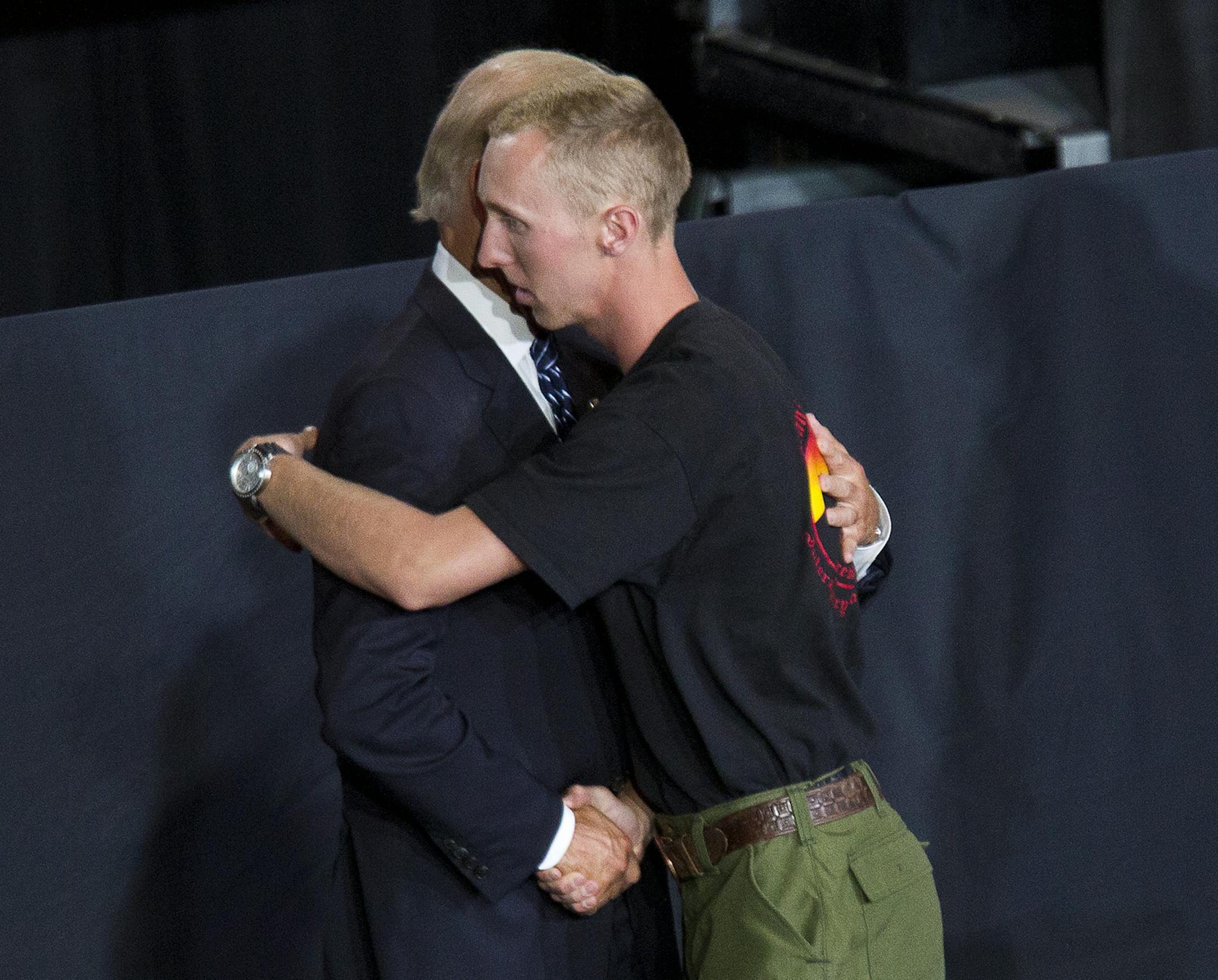 Brendan McDonough is greeted by Vice President Joe Biden during a memorial service for the 19 fallen firefighters at Tim's Toyota Center in Prescott Valley, Ariz. on Tuesday, July 9, 2013. Prescott's Granite Mountain Hotshots were overrun by smoke and fire while battling a blaze on a ridge in Yarnell, about 80 miles northwest of Phoenix on June 30, 2013. (AP Photo/The Arizona Republic, Michael Chow, Pool)