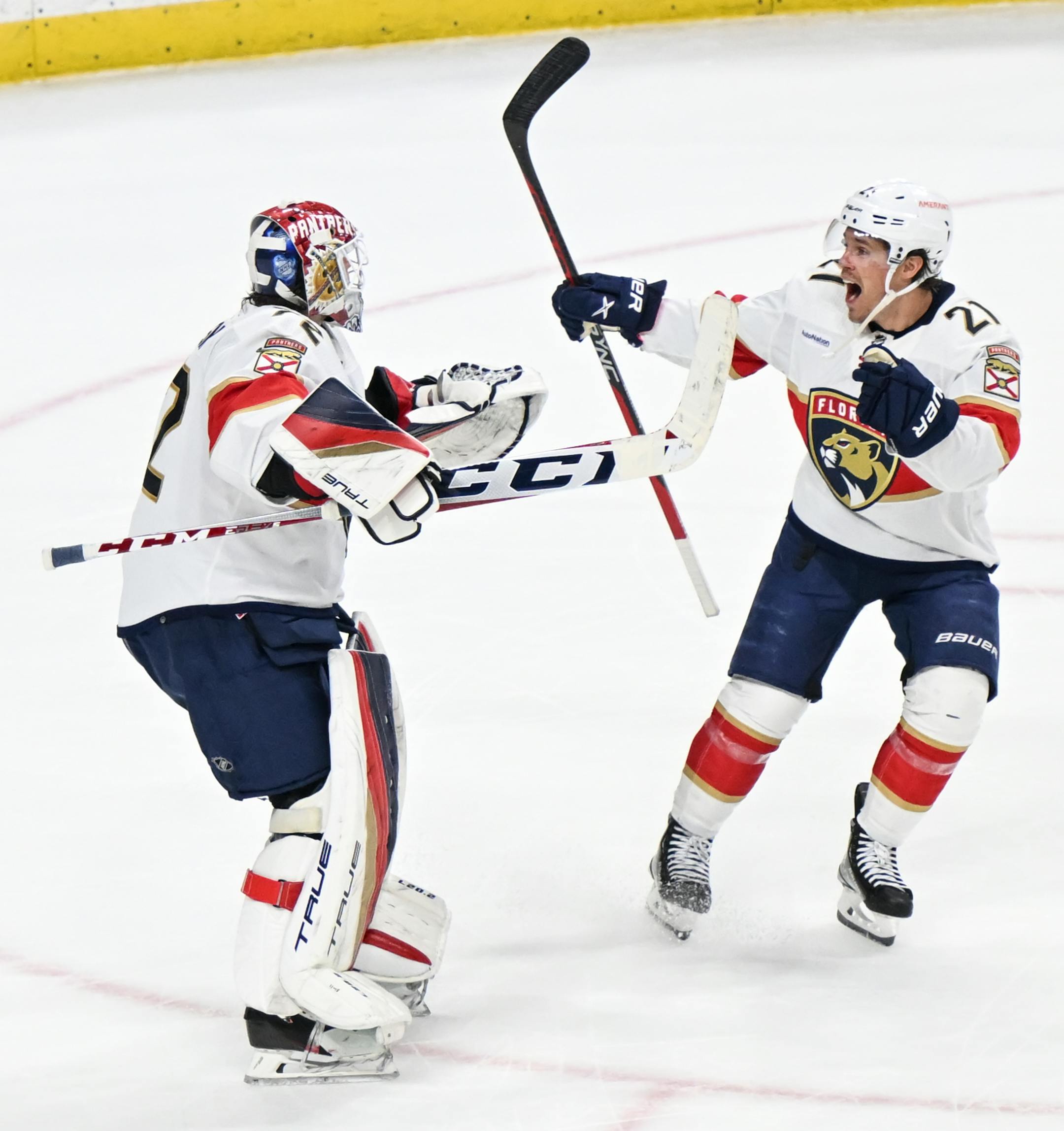 Florida Panthers goaltender Sergei Bobrovsky (72) and center Nick Cousins (21) celebrate their team's shootout win against the Minnesota Wild.