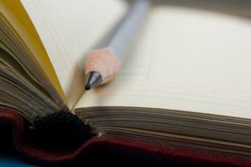 Notepad and pencil macro shot.