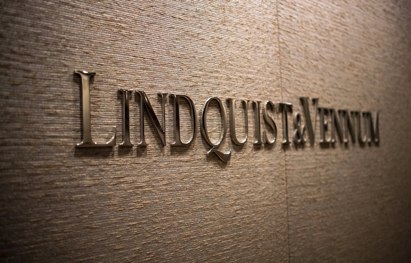 The company's branding in the old lobby. ] (AARON LAVINSKY/STAR TRIBUNE) aaron.lavinsky@startribune.com Law firms are known for their sprawling and sometimes braggadocios offices complete with large private corner suites reserved for partners. With their industry under attack by virtual upstarts like LegalZoom, law firms are experimenting with reducing and repurposing office space as a cost-saving measure and a retention tool. We photograph Dennis O'Malley, managing partner at Lindquist & Vennum