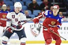 United States forward Casey Mittelstadt (11) and Russia forward Mikhail Maltsev (13) vie for the puck during the first period of a quarterfinal in the