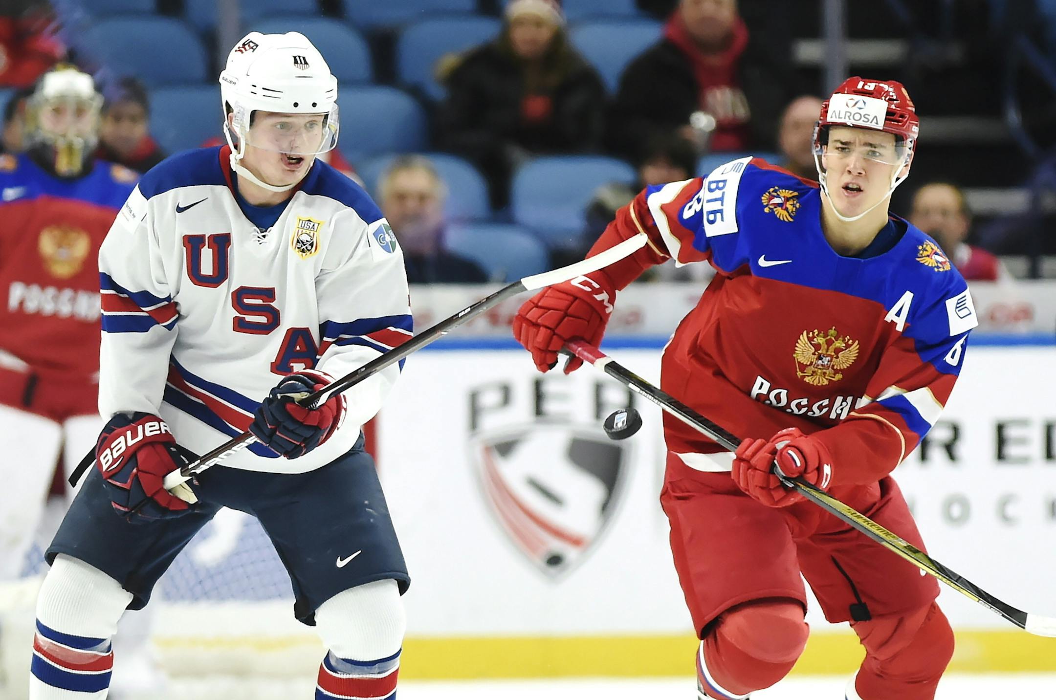 United States forward Casey Mittelstadt (11) and Russia forward Mikhail Maltsev (13) vie for the puck during the first period of a quarterfinal in the IIHF world junior hockey championships in Buffalo, N.Y., Tuesday, Jan. 2, 2018. (Nathan Denette/The Canadian Press via AP)