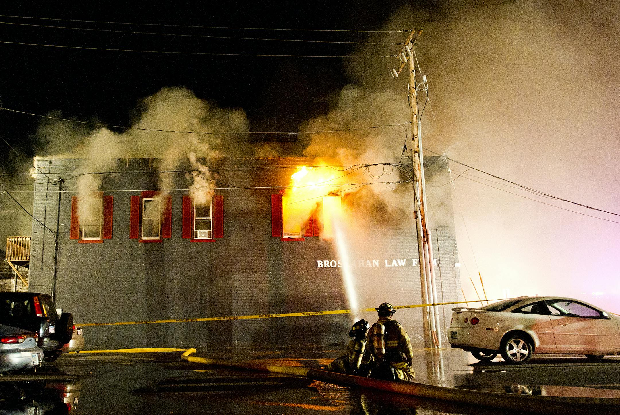 Firefighters battle a blaze in several downtown buildings early Friday, Sept. 13, 2013, in Winona, Minn.